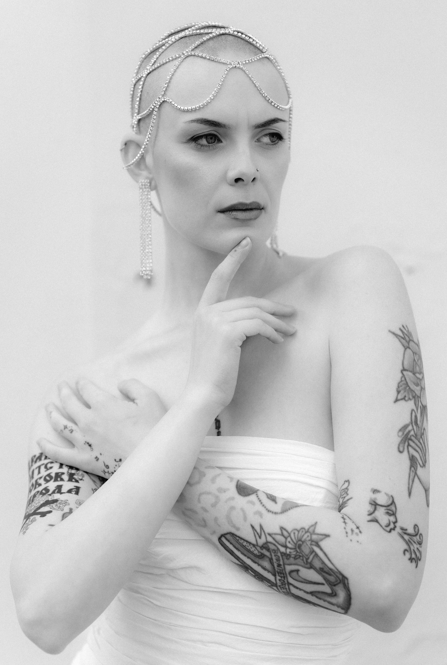 A series of black and white artistic bridal portraits showing elegant poses with visible tattoos and strapless gown details.