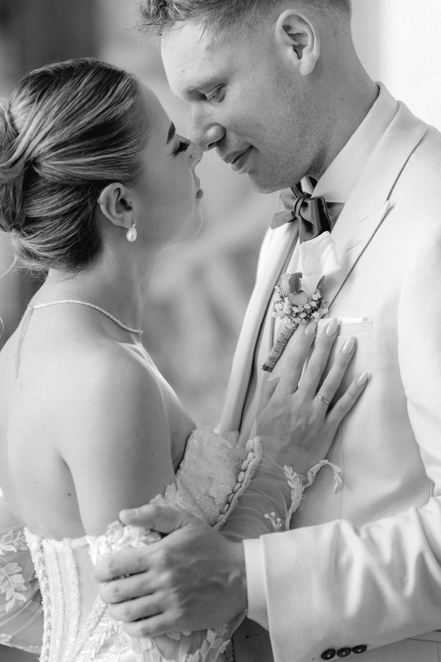 A romantic black and white photo series showing tender moments between a couple in wedding attire. Schloss Ludwigsburg
