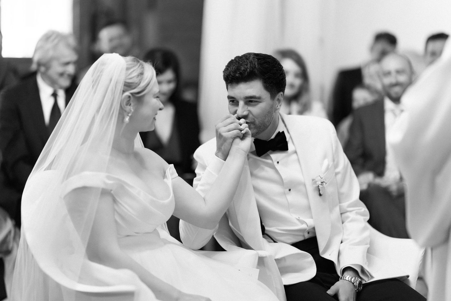 A black and white photo collage of a wedding celebration showing dancing and joyful moments at a reception.
