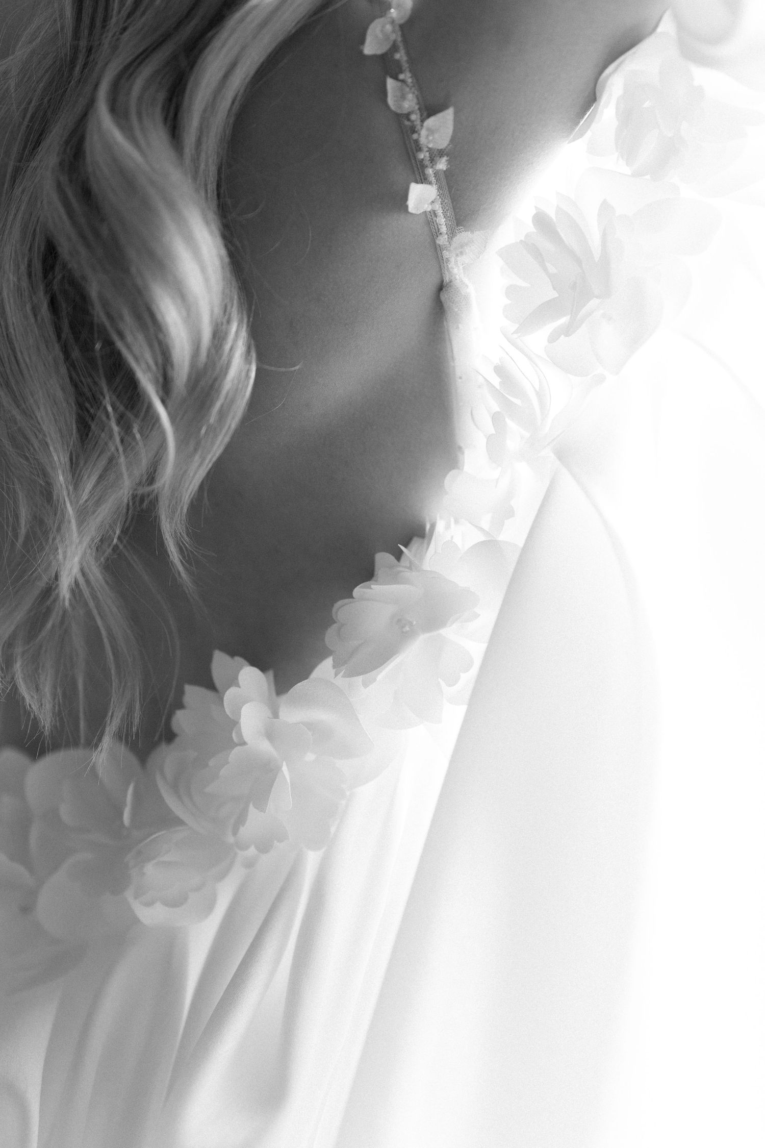 Ethereal close-up of flowing white fabric and soft feminine details.