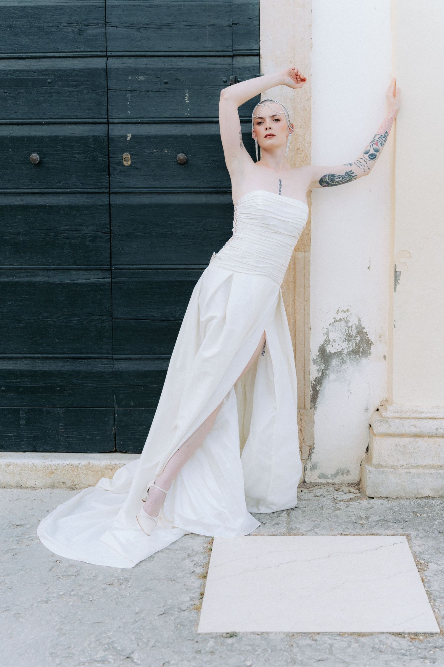 A series of artistic photos showing the bottom half of a white wedding dress against a dark door and light wall.