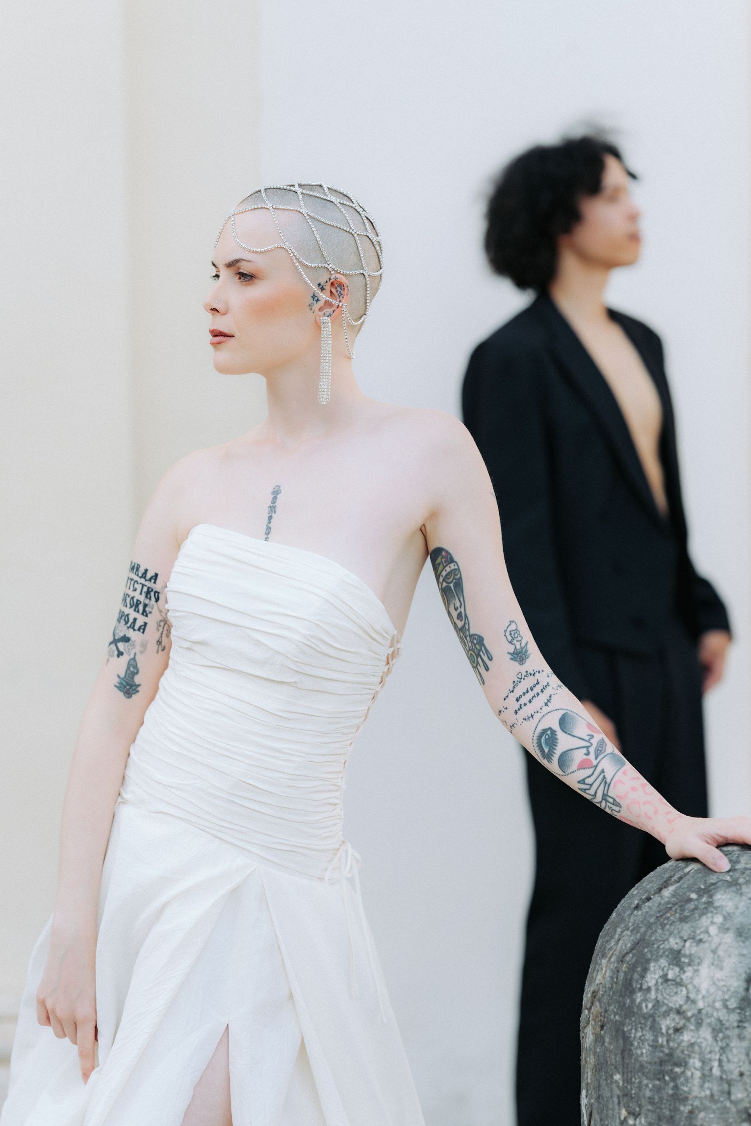 A series of artistic fashion photos showing contrast between a figure in white dress and another in black attire.