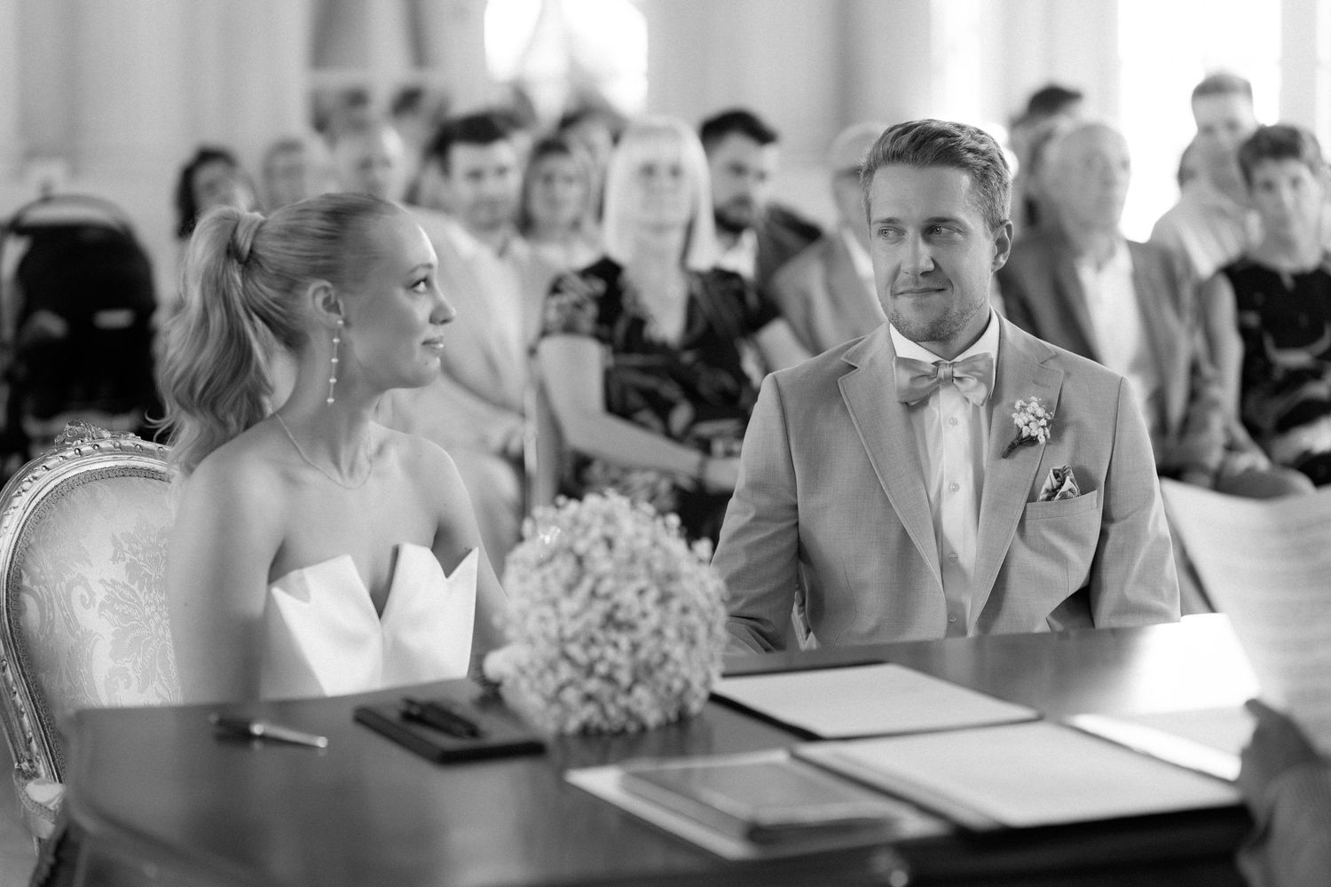 Wedding reception guests seated at tables in a black and white photograph. Schloss Solitude