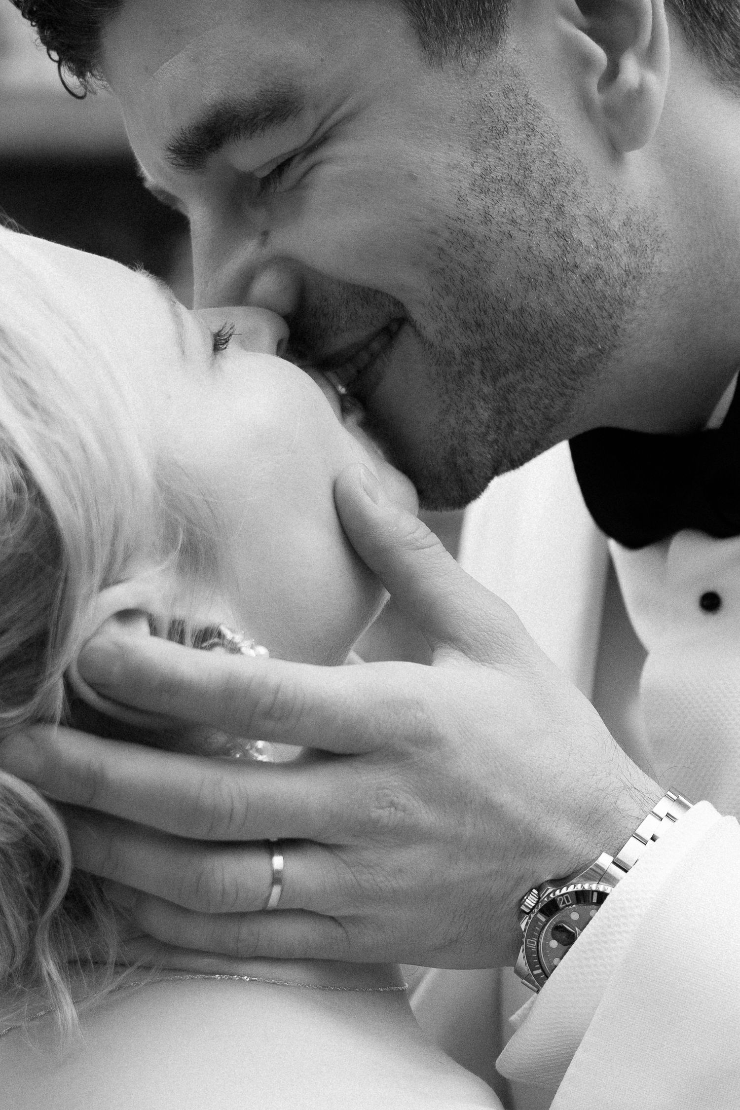 A romantic black and white photo series showing close-up passionate kisses between a couple.