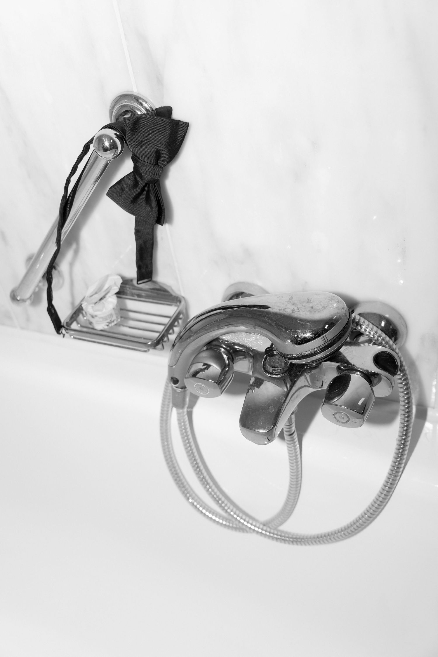 Vintage medical prosthetic device with mechanical joints and straps photographed in black and white against white background.