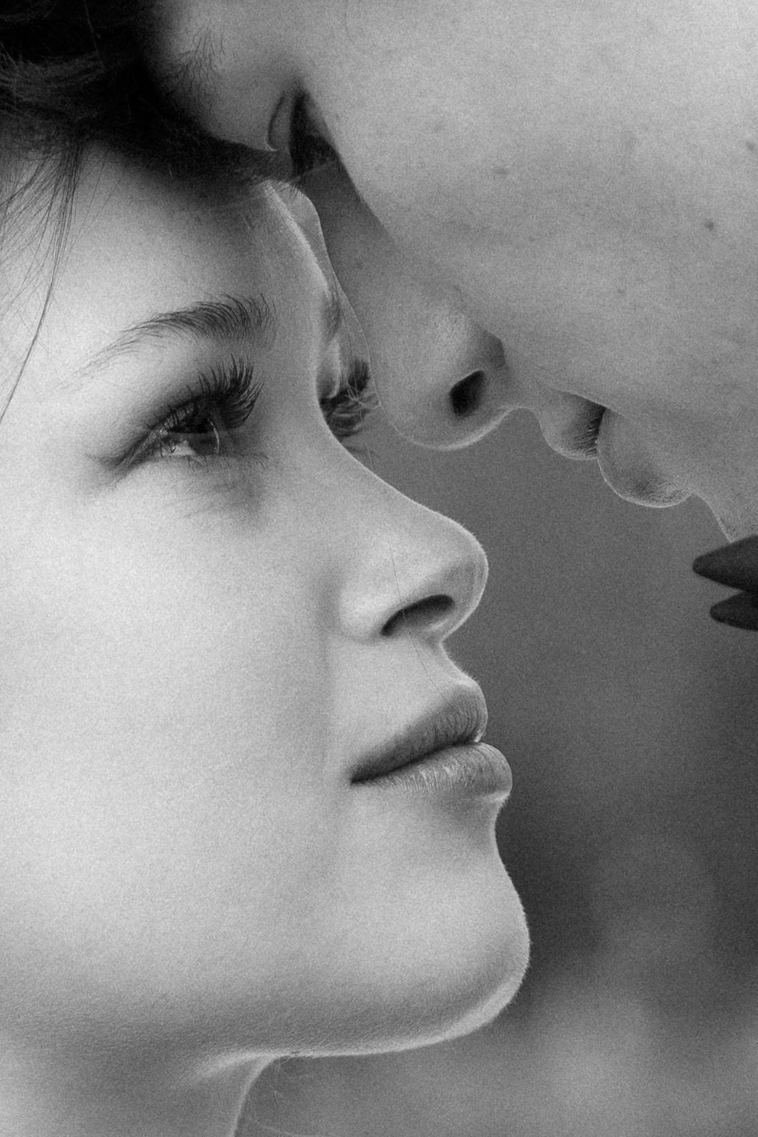 A series of black and white close-up profile shots showing a person blowing soap bubbles in a dreamy artistic style.