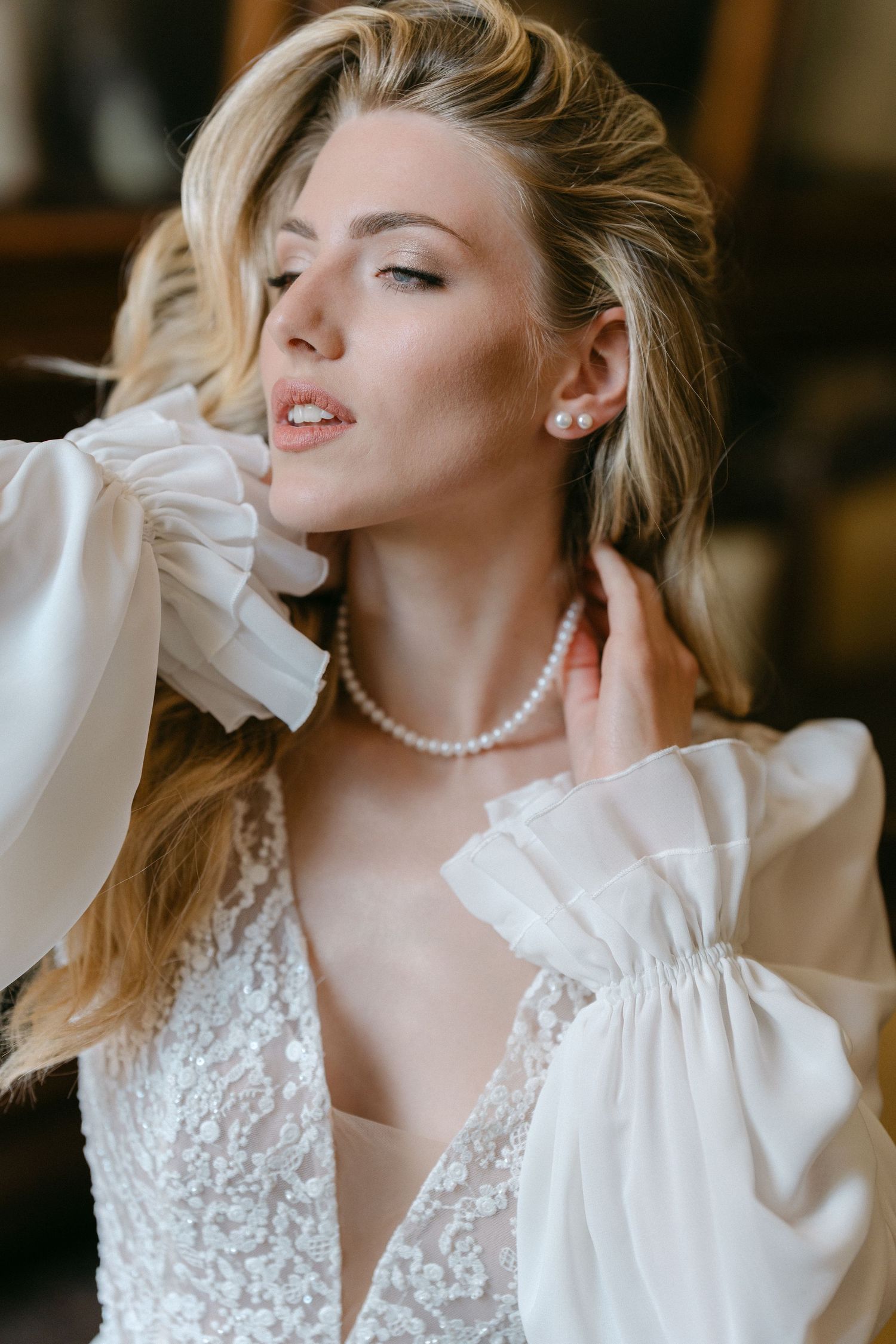 A series of romantic bridal portraits featuring a white lace dress, pearl necklace, and elegant poses in soft lighting. Wedding Verona