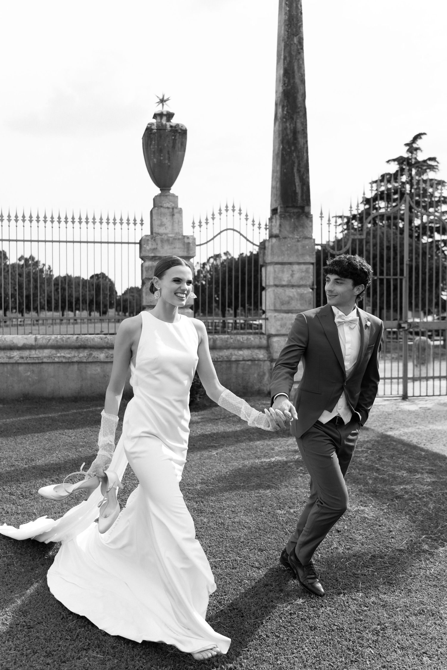 A couple in wedding attire playfully dances and poses together in a series of black and white photos on a lawn. Villa Mosconi Bertani