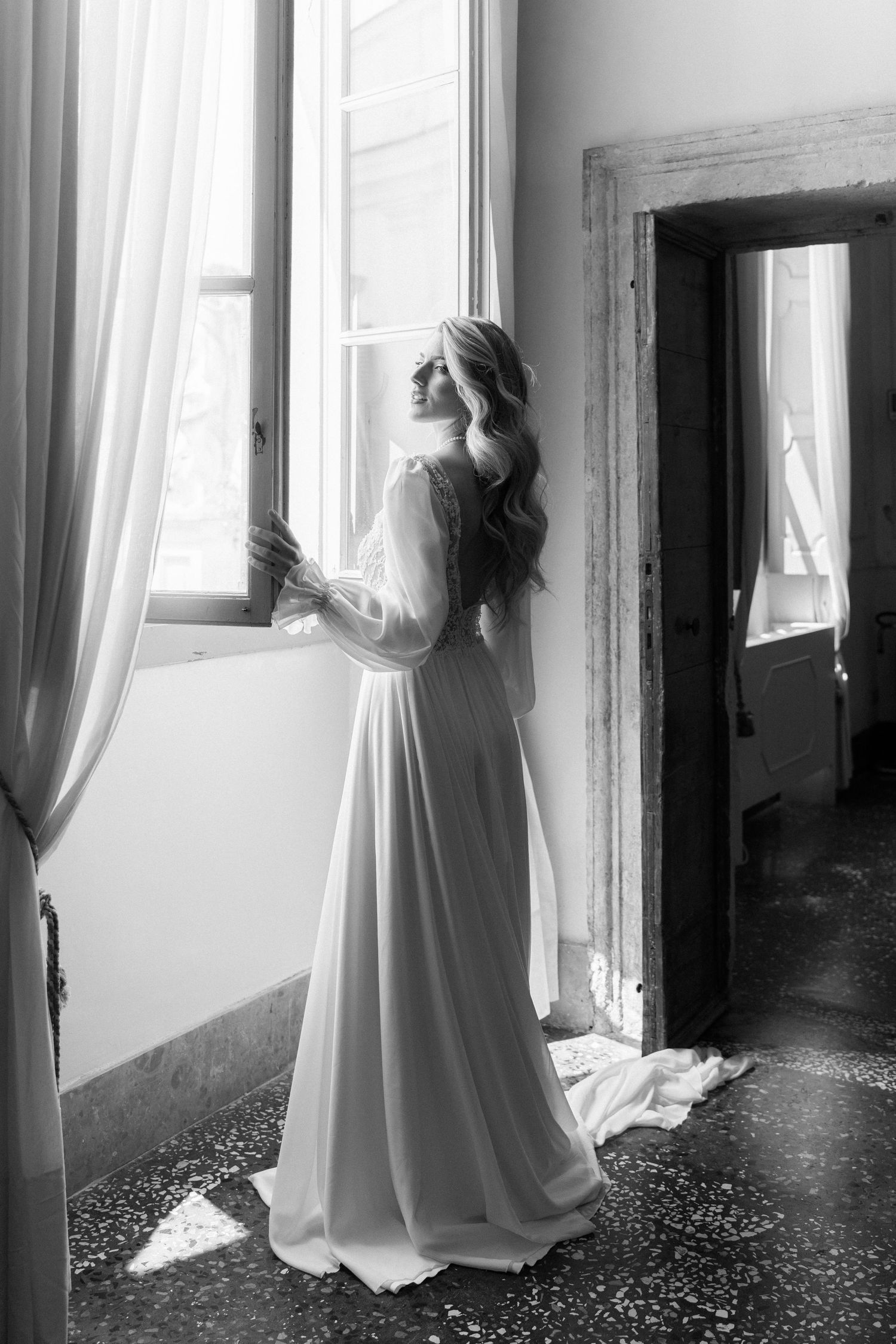 A series of black and white photos showing a figure in white dress standing by windows in an empty hallway. Wedding Verona