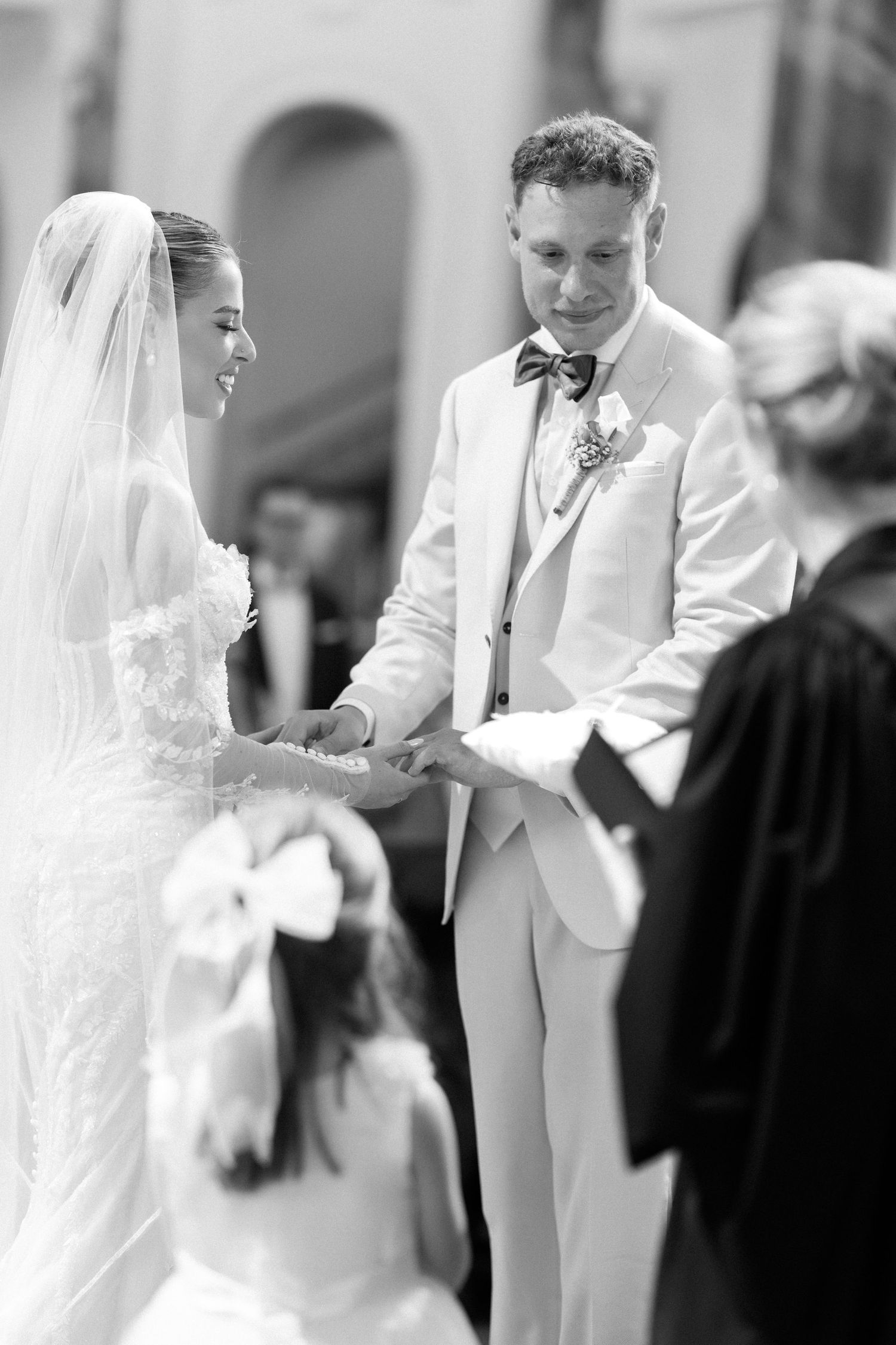 A black and white photo sequence showing a couple sharing tender moments during their wedding ceremony.