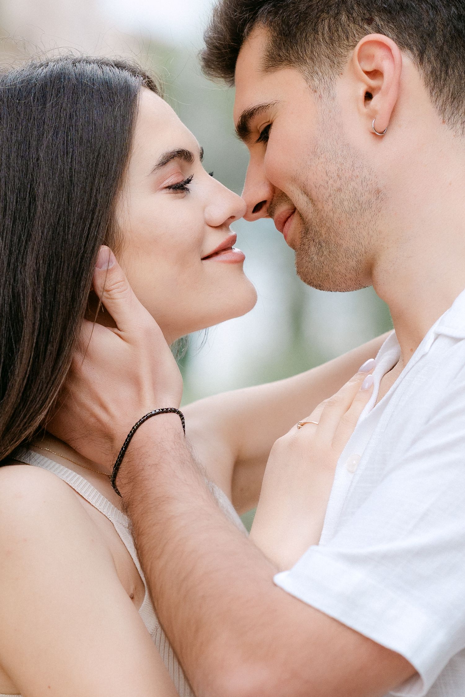 Romantic close-up series showing tender moments between a couple in white clothing.