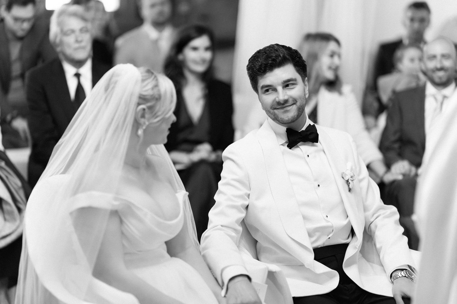 A black and white photo collage shows joyful moments at a wedding celebration with dancing and laughter.