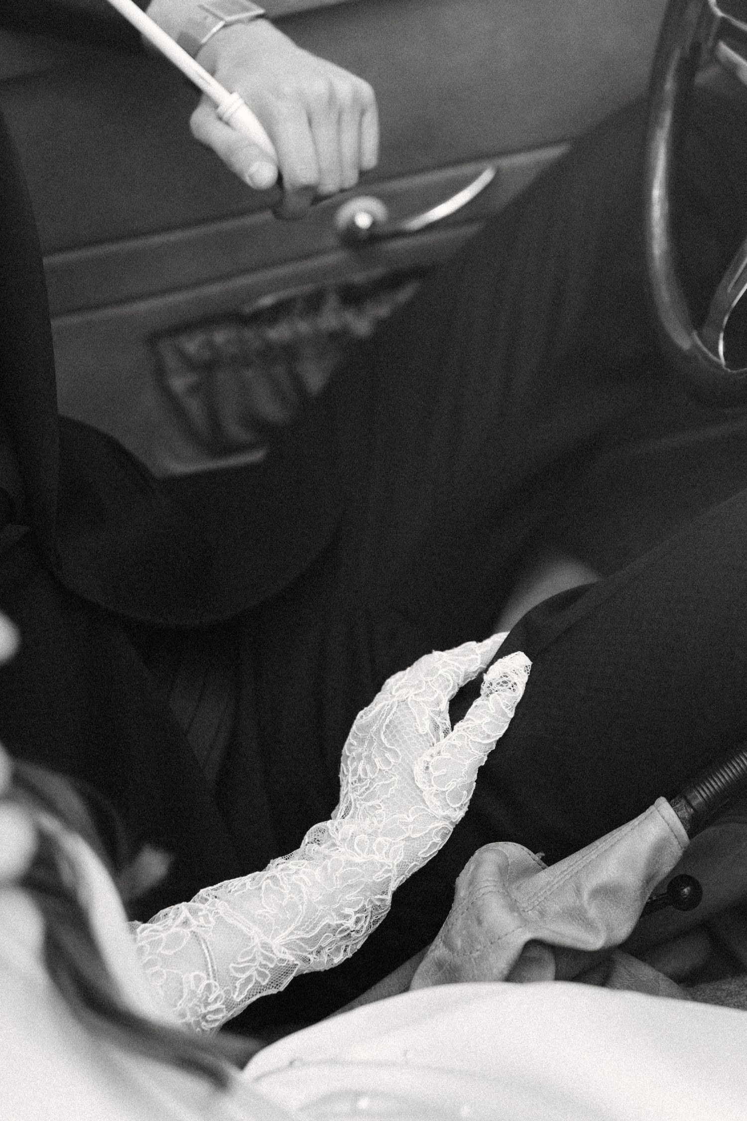 Black and white photo sequence showing hands cutting a white lace wedding dress fabric with scissors.
