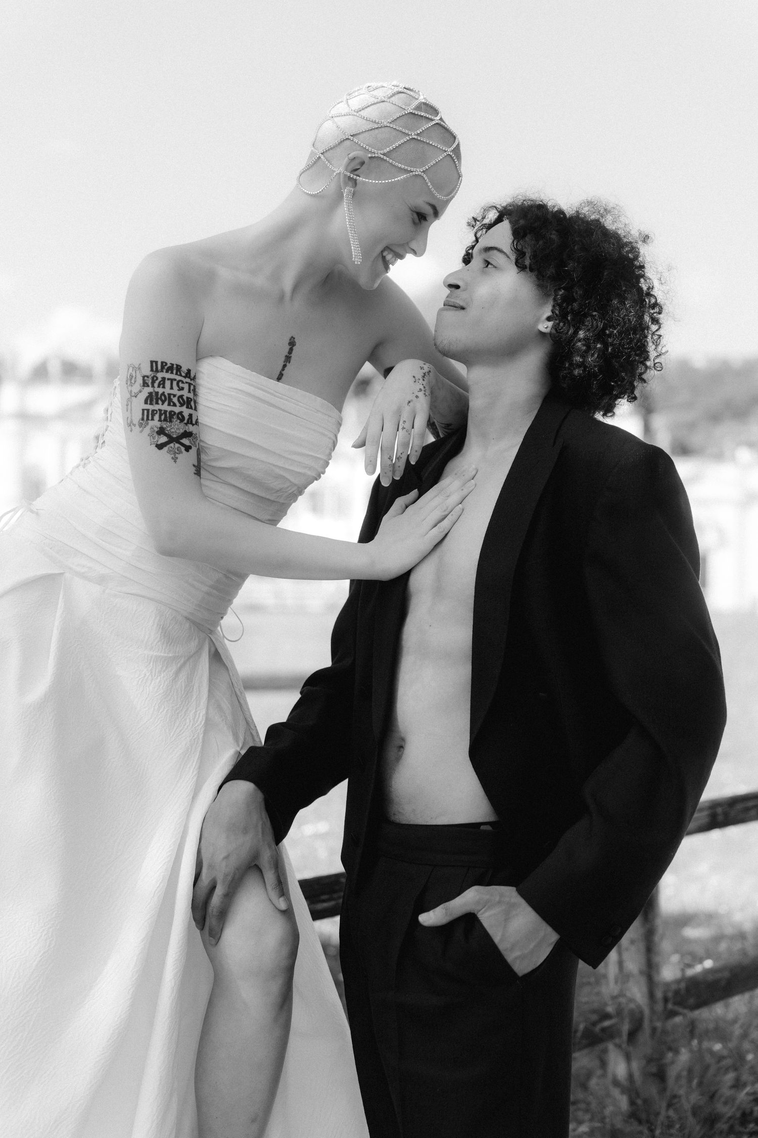 Black and white artistic fashion photos showing intimate poses between two people in contrasting black and white outfits.