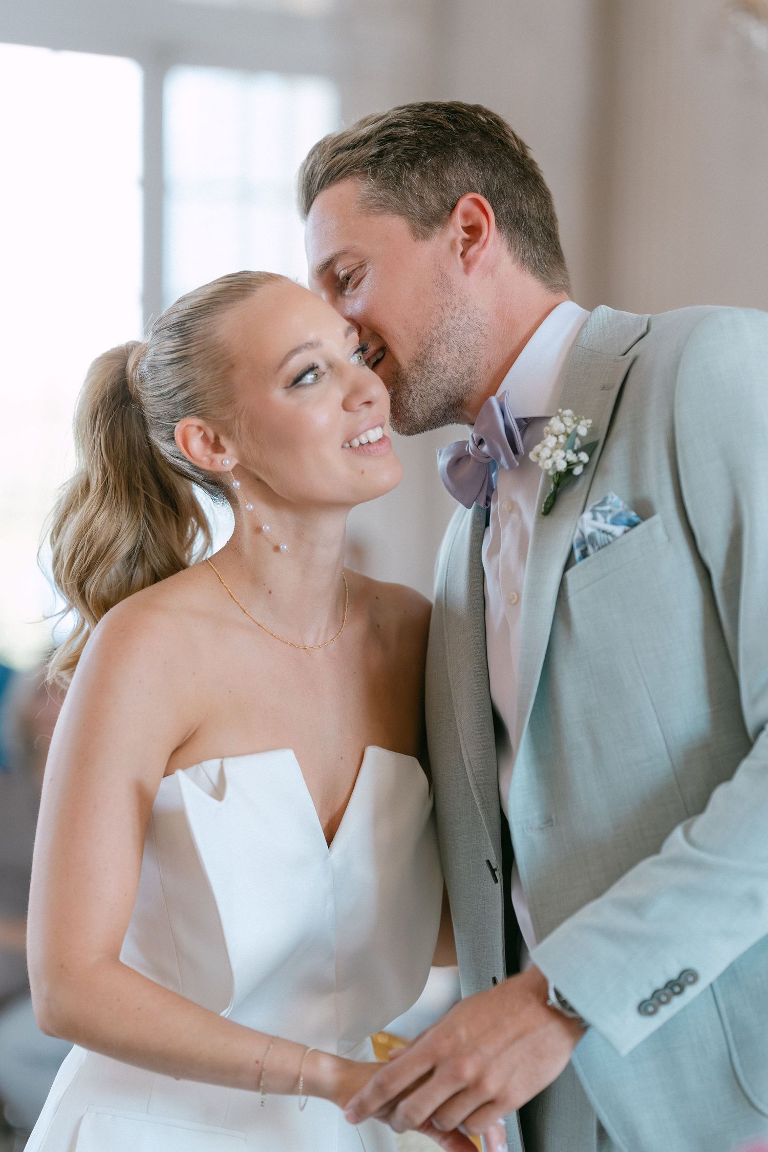 A romantic series of wedding photos showing tender moments between a couple in light gray and white attire. Schloss Solitude