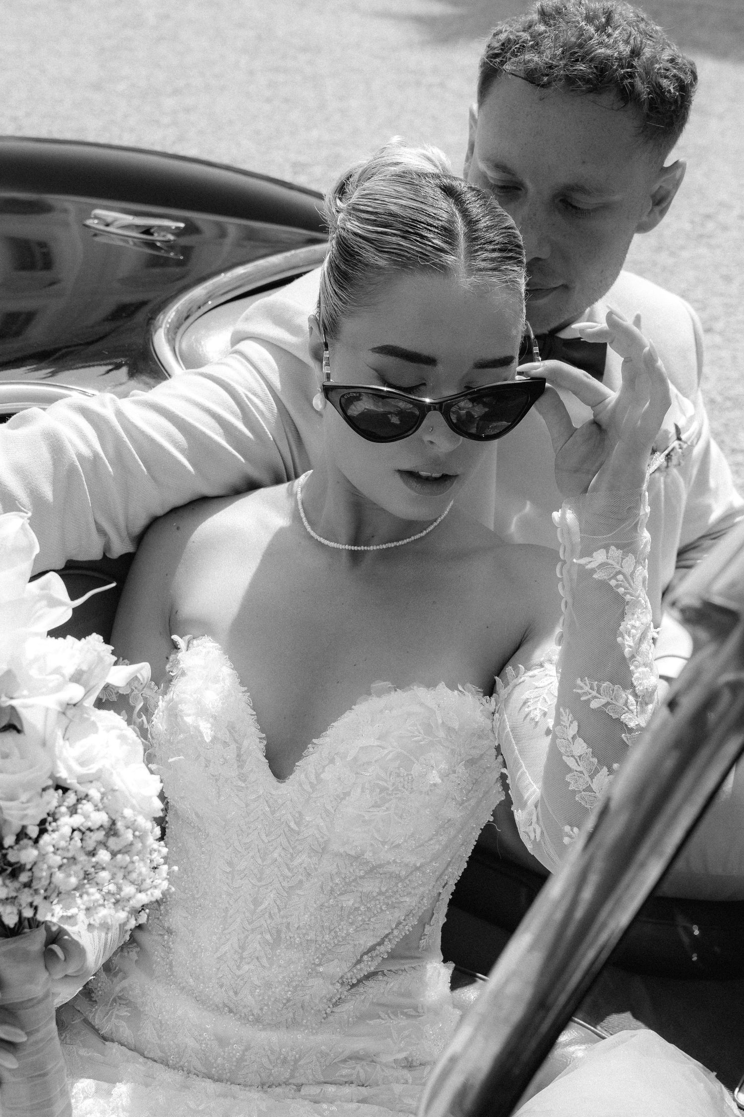A series of black and white wedding photos showing a couple sitting together in a car. Schloss Ludwigsburg