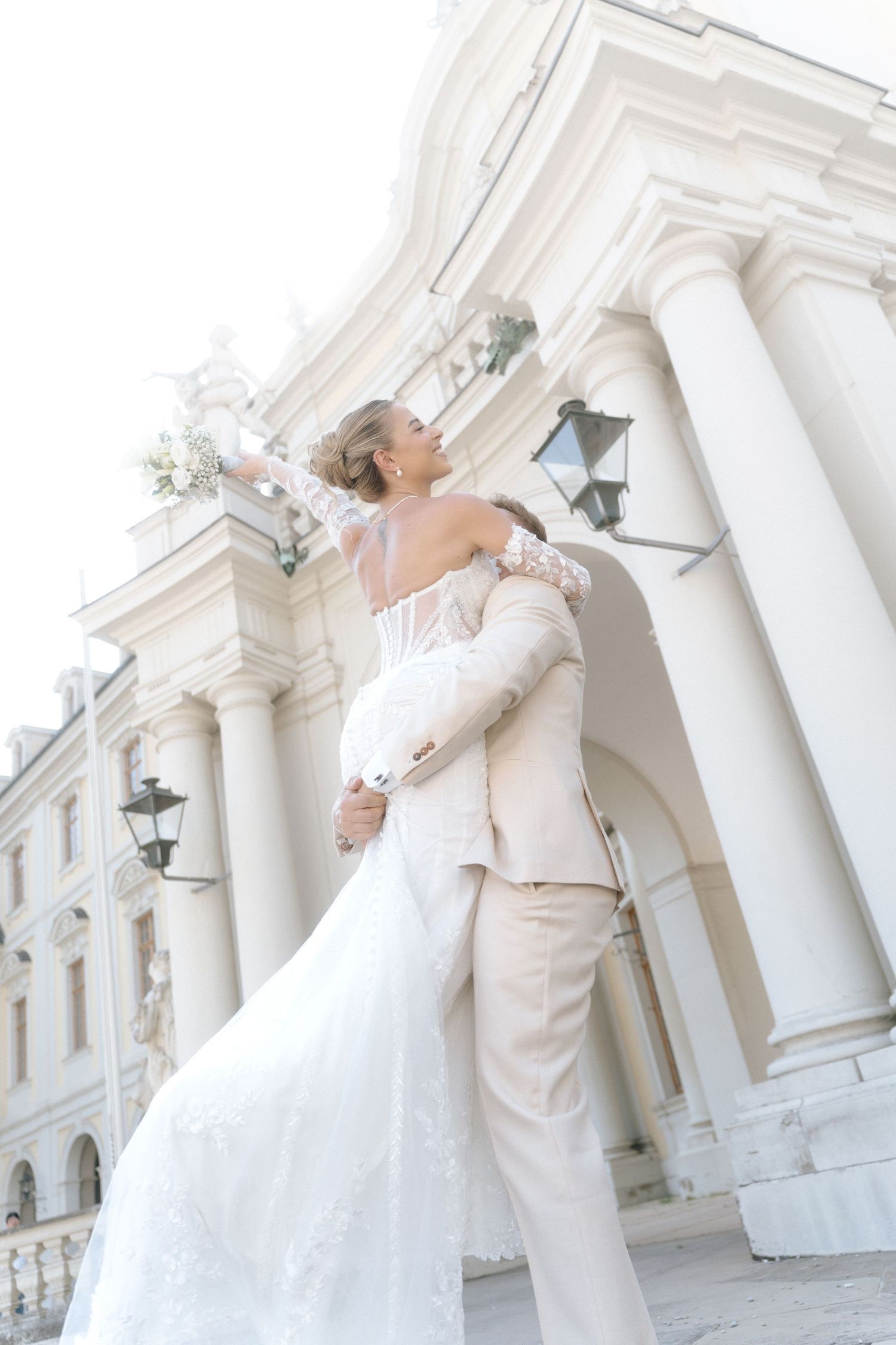 A romantic wedding couple poses dramatically against white classical columns in a sequence of elegant photos. Schloss Ludwigsburg