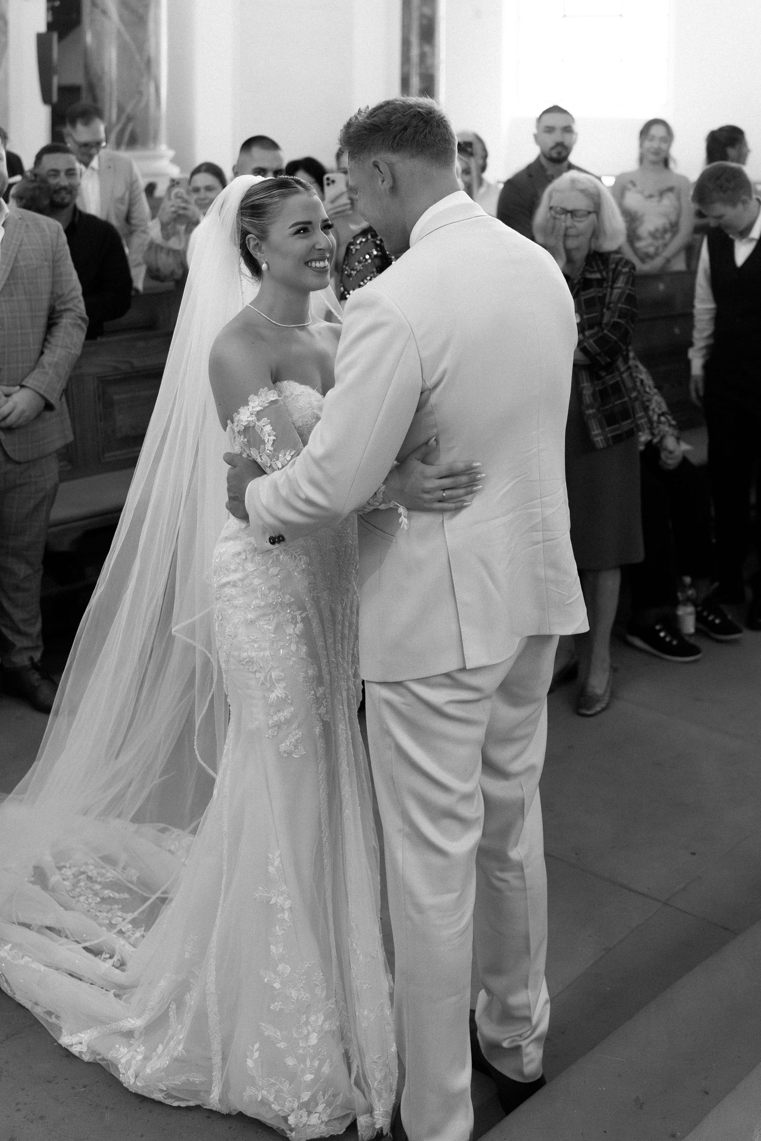 Black and white photo series showing a couple dancing at their wedding reception in formal white attire.