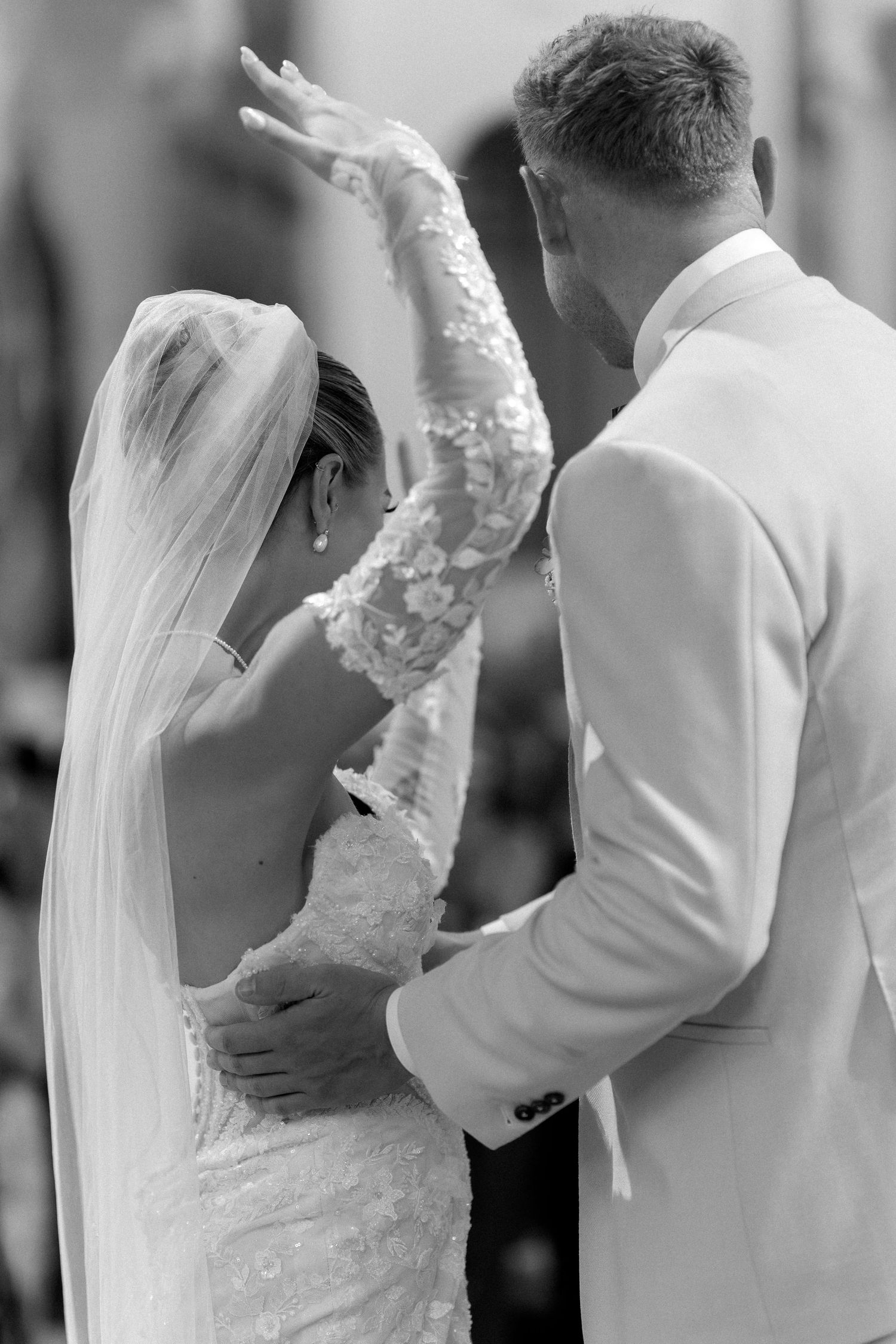 Black and white wedding photos show a romantic sequence of a couple embracing and dancing together.