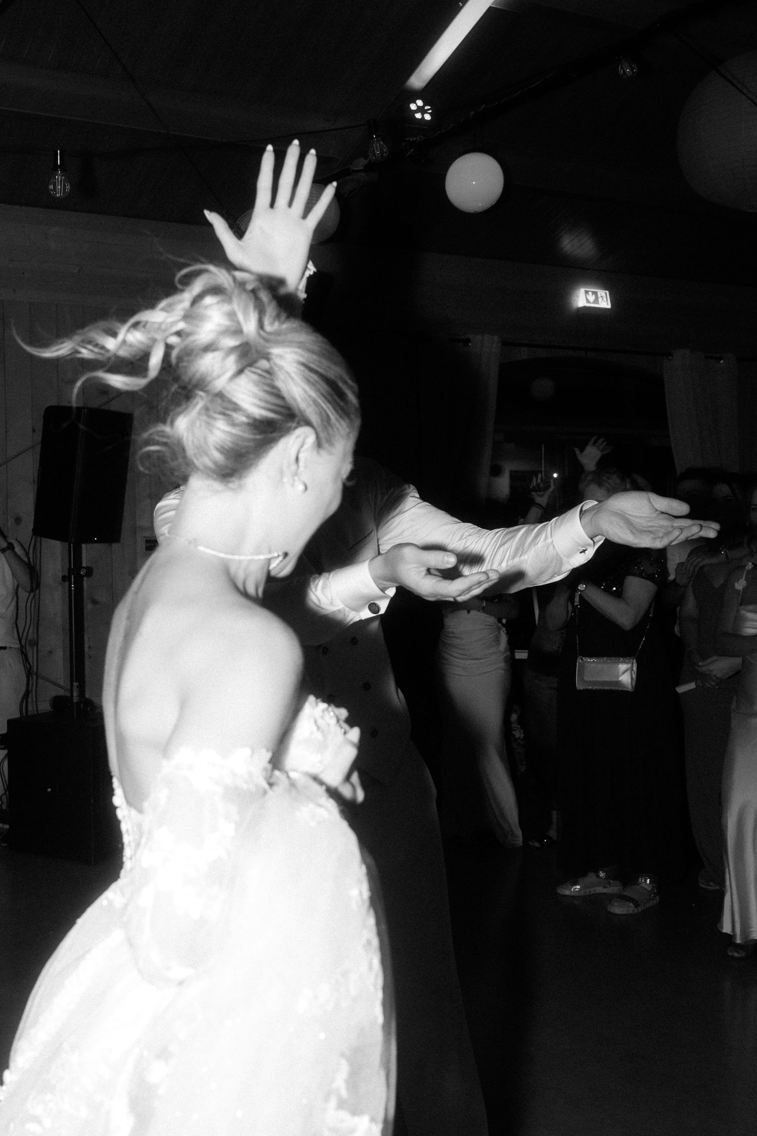Black and white photo sequence showing a couple dancing and spinning on a dimly lit dance floor.