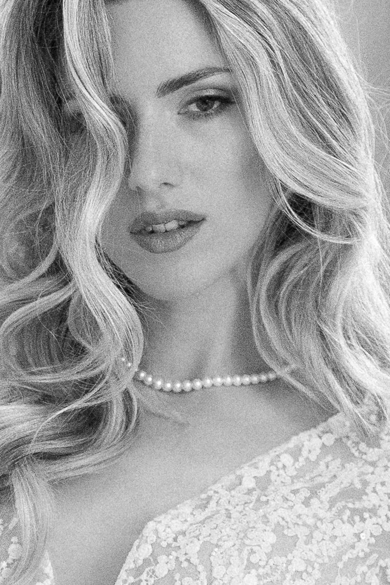 Black and white portrait series showing close-up shots of a woman with wavy blonde hair wearing pearls and lace. Wedding Verona