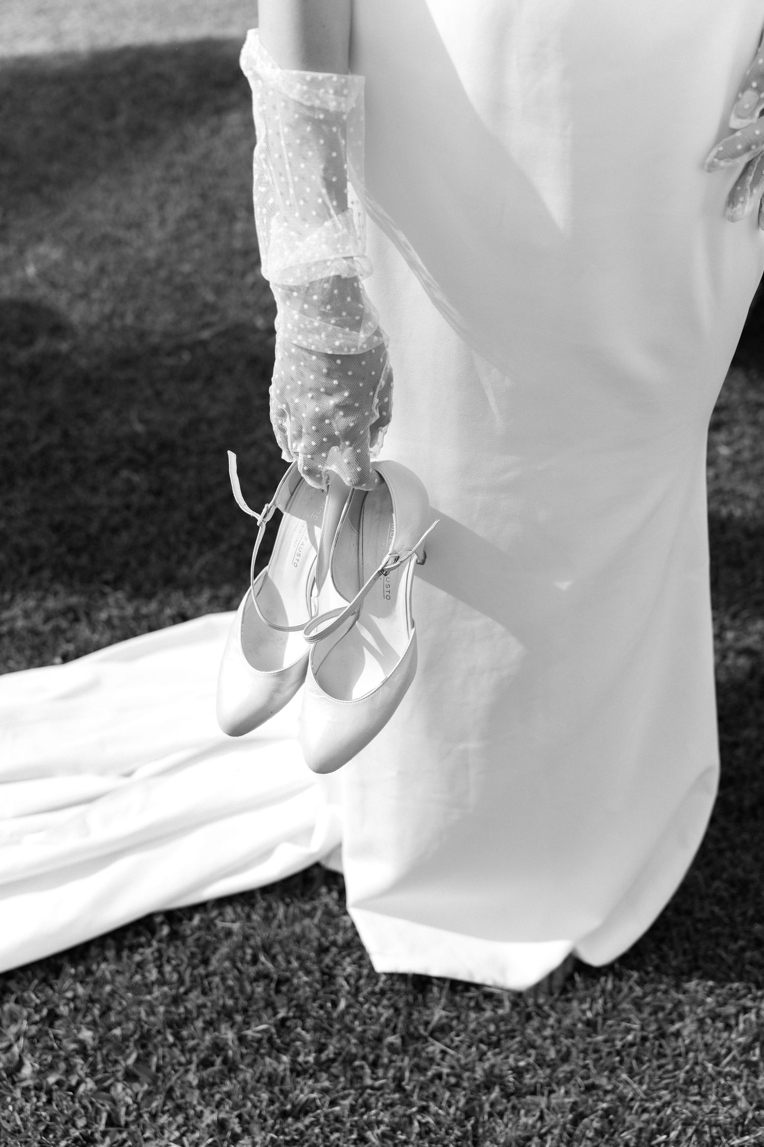 A series of black and white photos showing white bridal shoes and dress hem against dark grass. Villa Mosconi Bertani