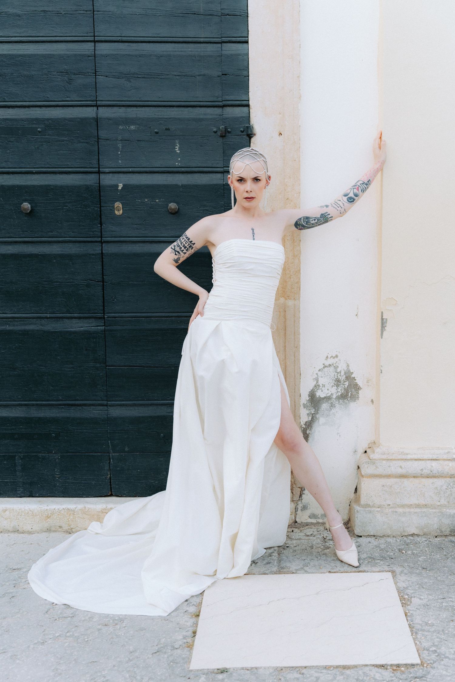 A series of artistic photos showing parts of a flowing white wedding dress against a dark wall and architectural details.