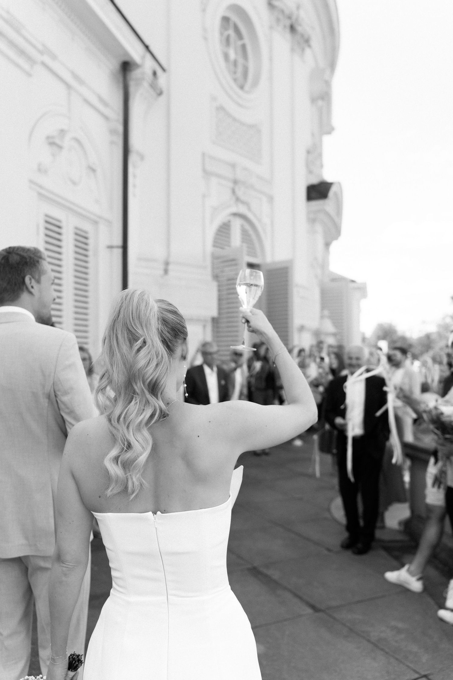 A sequence of black and white photos showing a bride in a strapless wedding dress raising her arms in celebration. Schloss Solitude