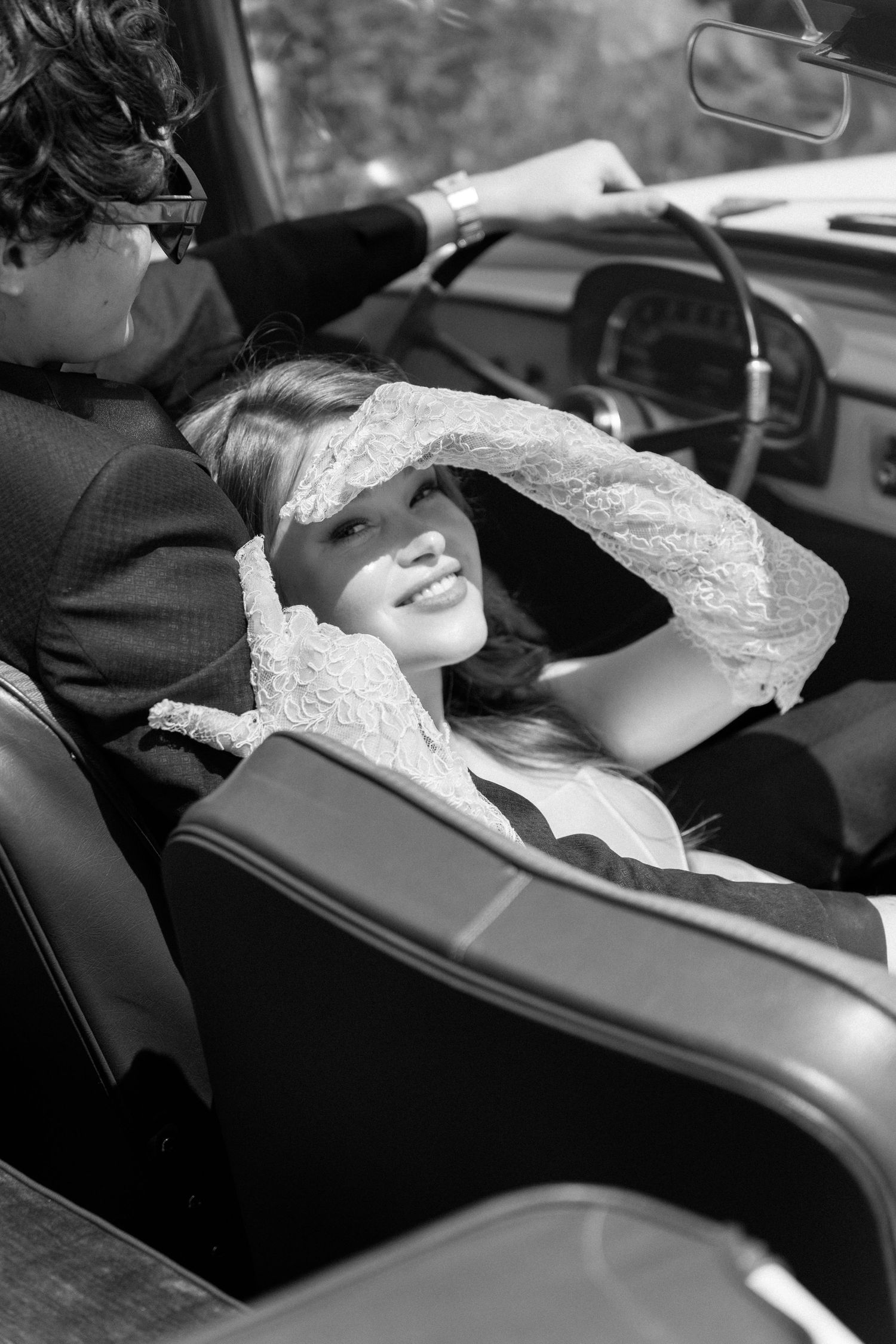 A sequence of black and white images showing someone reclining in what appears to be a car seat.
