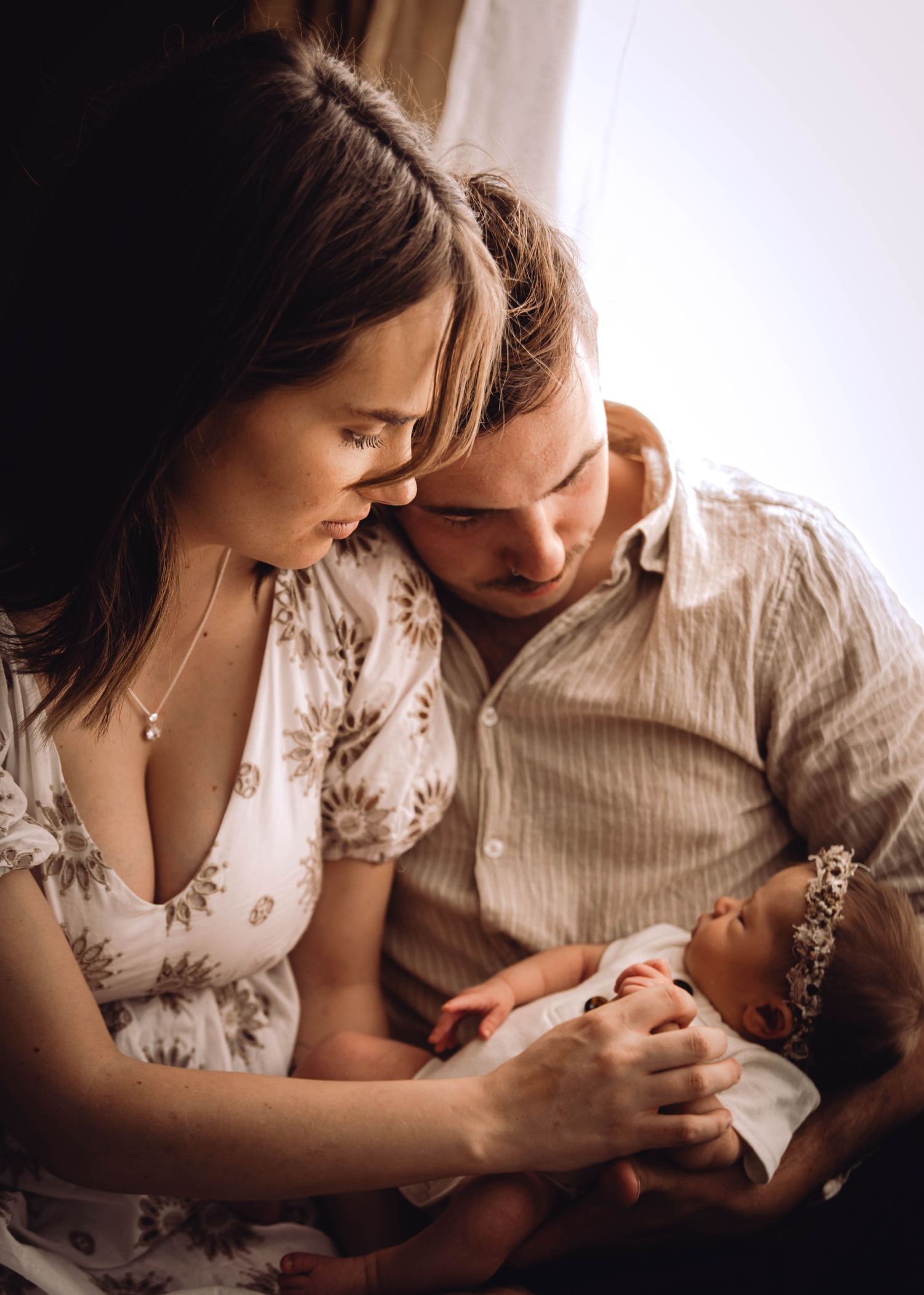 Intimate moment between new parents with their baby. Family and Newborn Photography