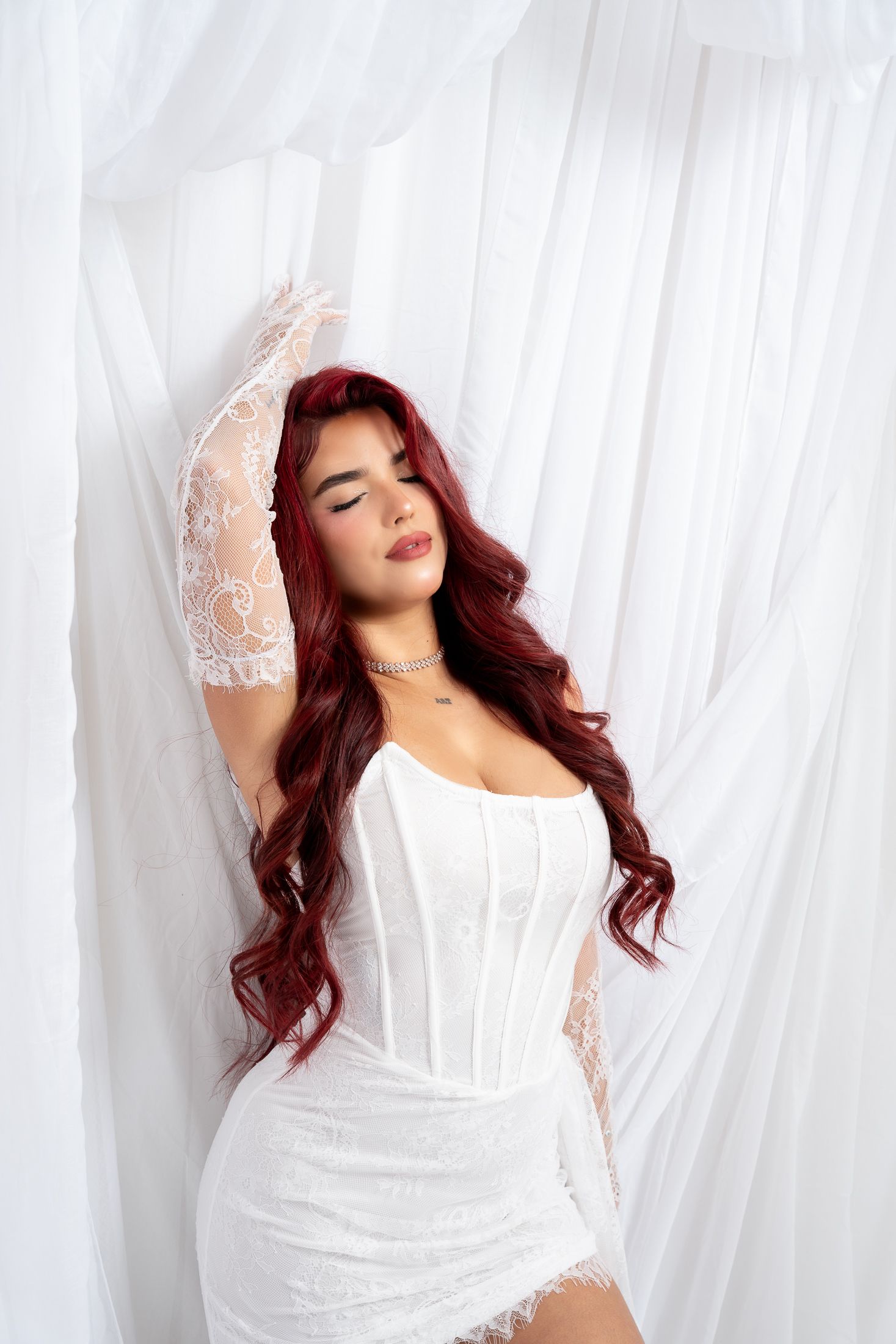 Ethereal portrait session with white corset and delicate lace sleeves.