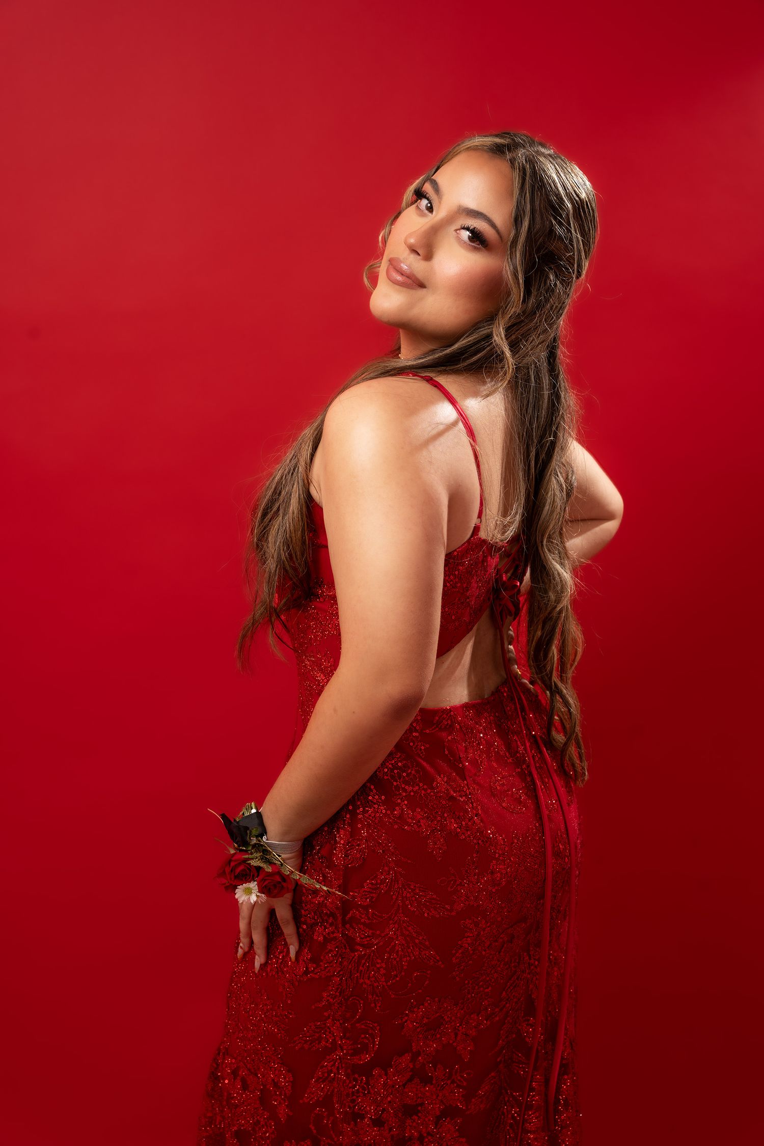 Fashion portrait series featuring a sparkling red evening gown against red background.