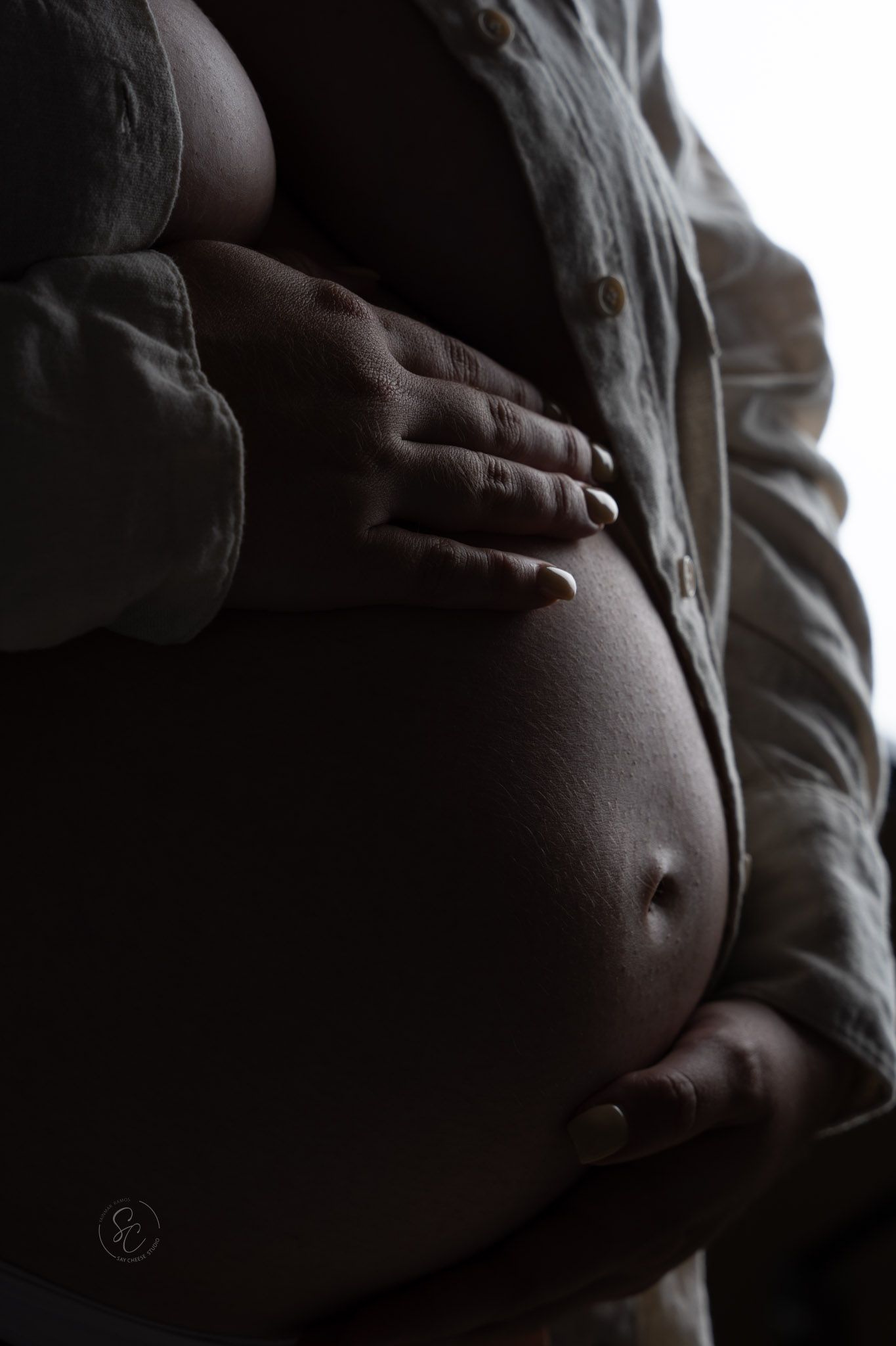 Intimate black and white maternity photos focusing on belly silhouette.