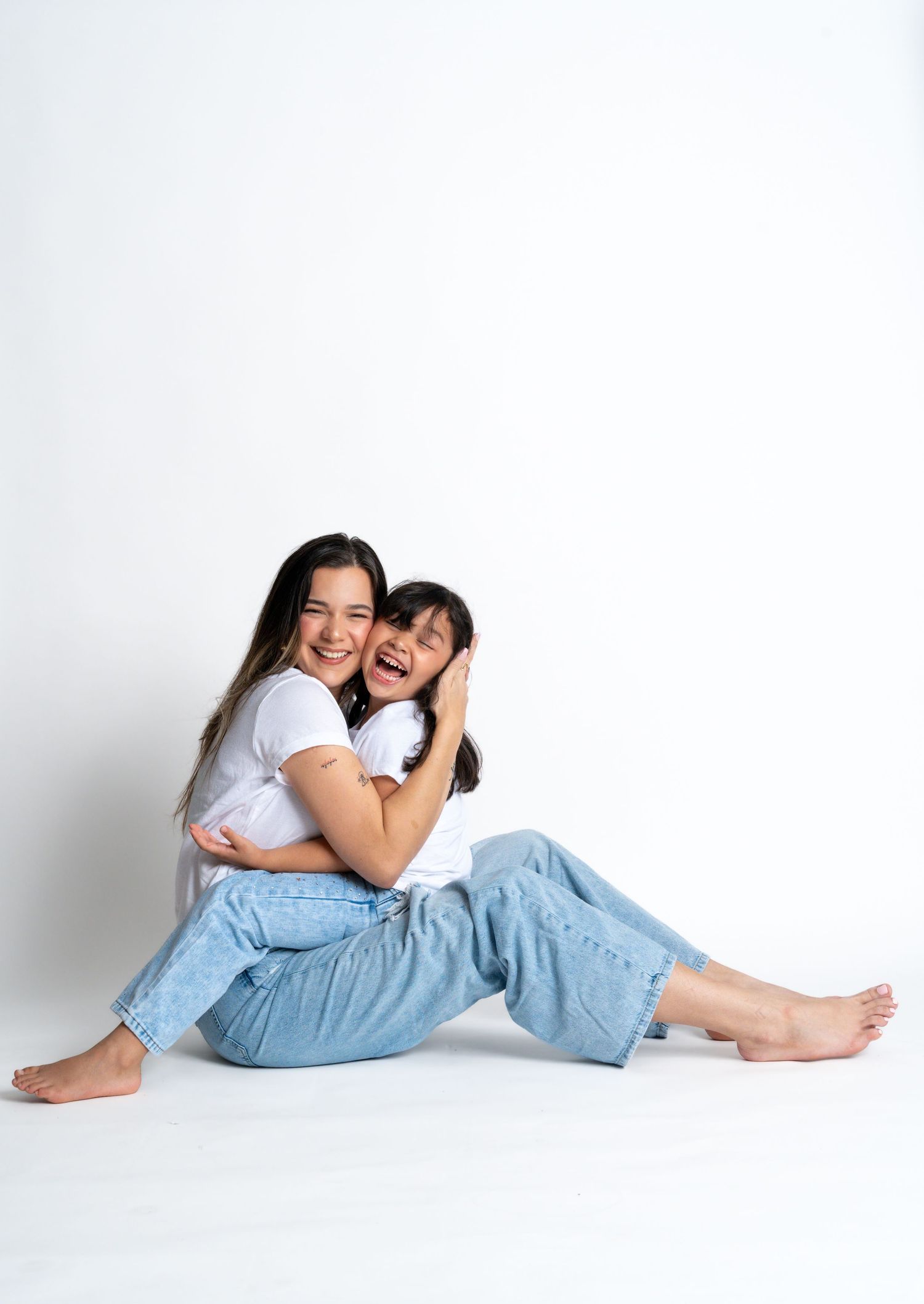 Casual lifestyle poses on white background wearing denim and white tops.