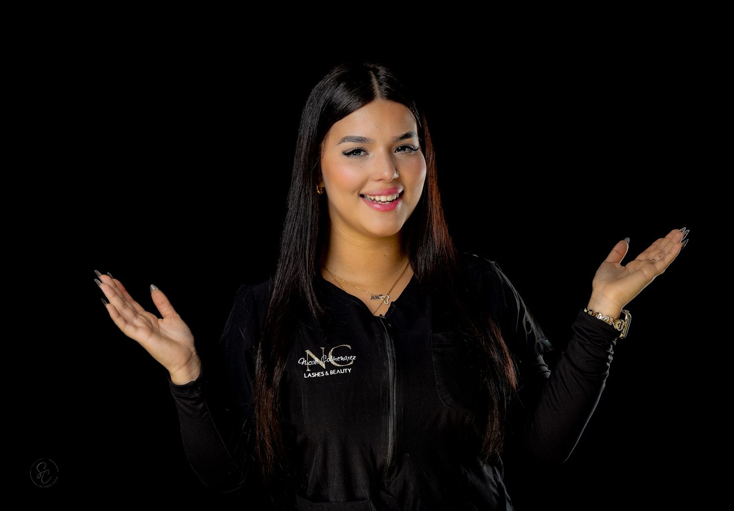 Woman in black sweater gestures expressively during studio photography session.