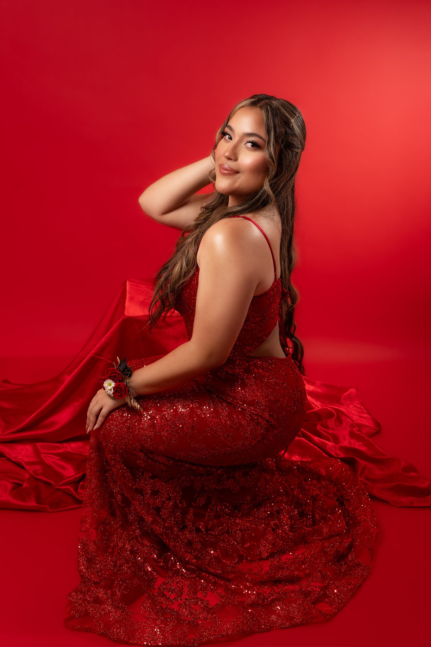 Dramatic fashion photos against vibrant red background with sparkly red gown.