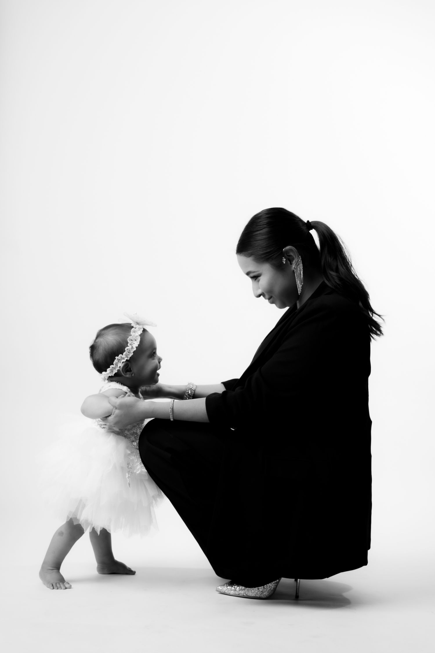 Black and white minimalist portrait series showing interaction with white stuffed animal.