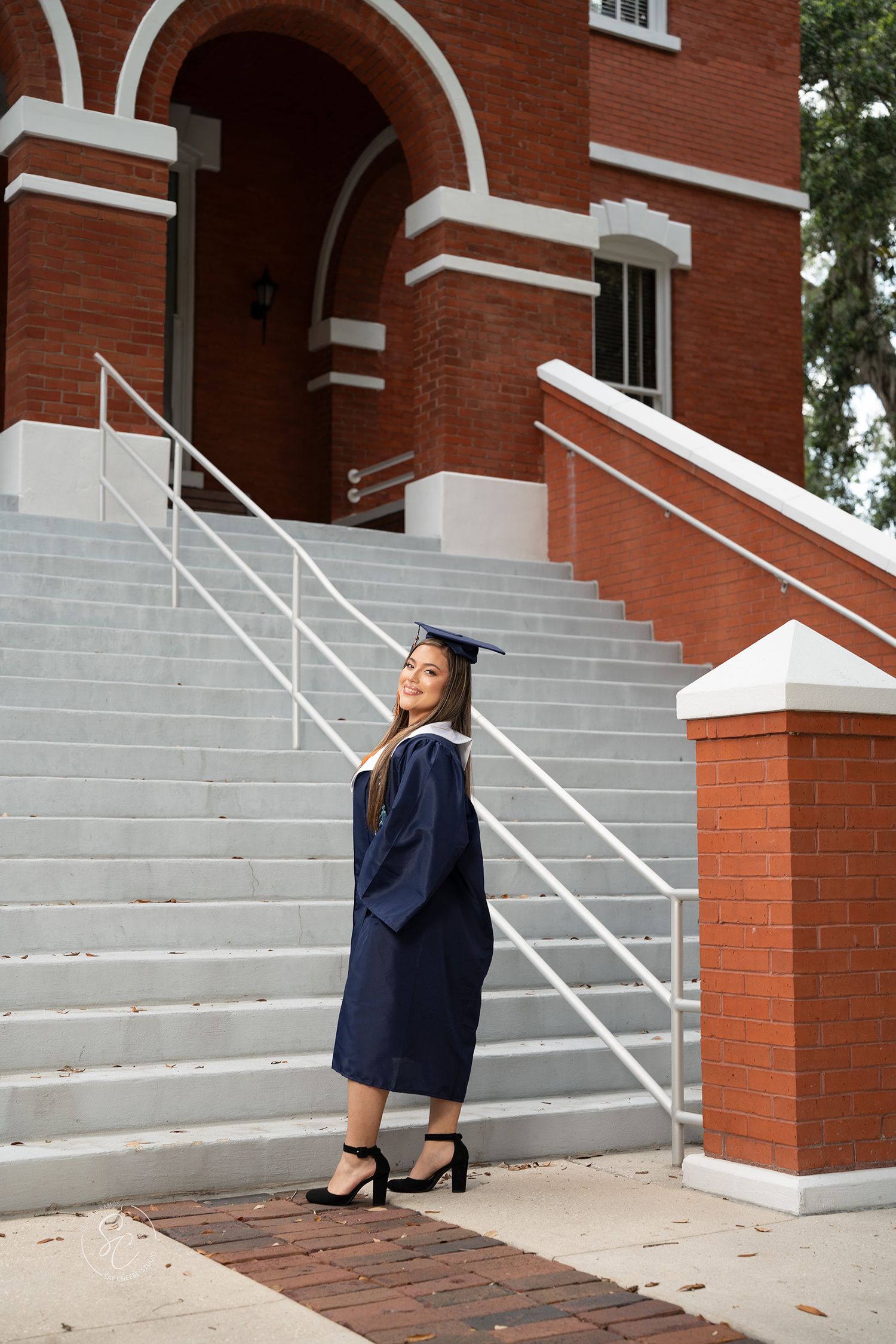 A series of photos showing someone in graduation attire posing on concrete steps in front of a red brick building.