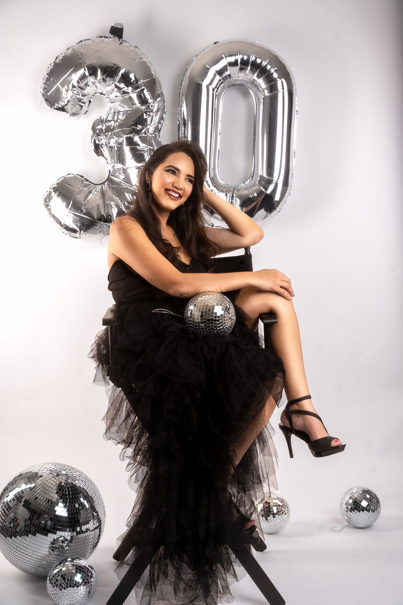 Elegant portrait session with silver balloons and black evening wear.