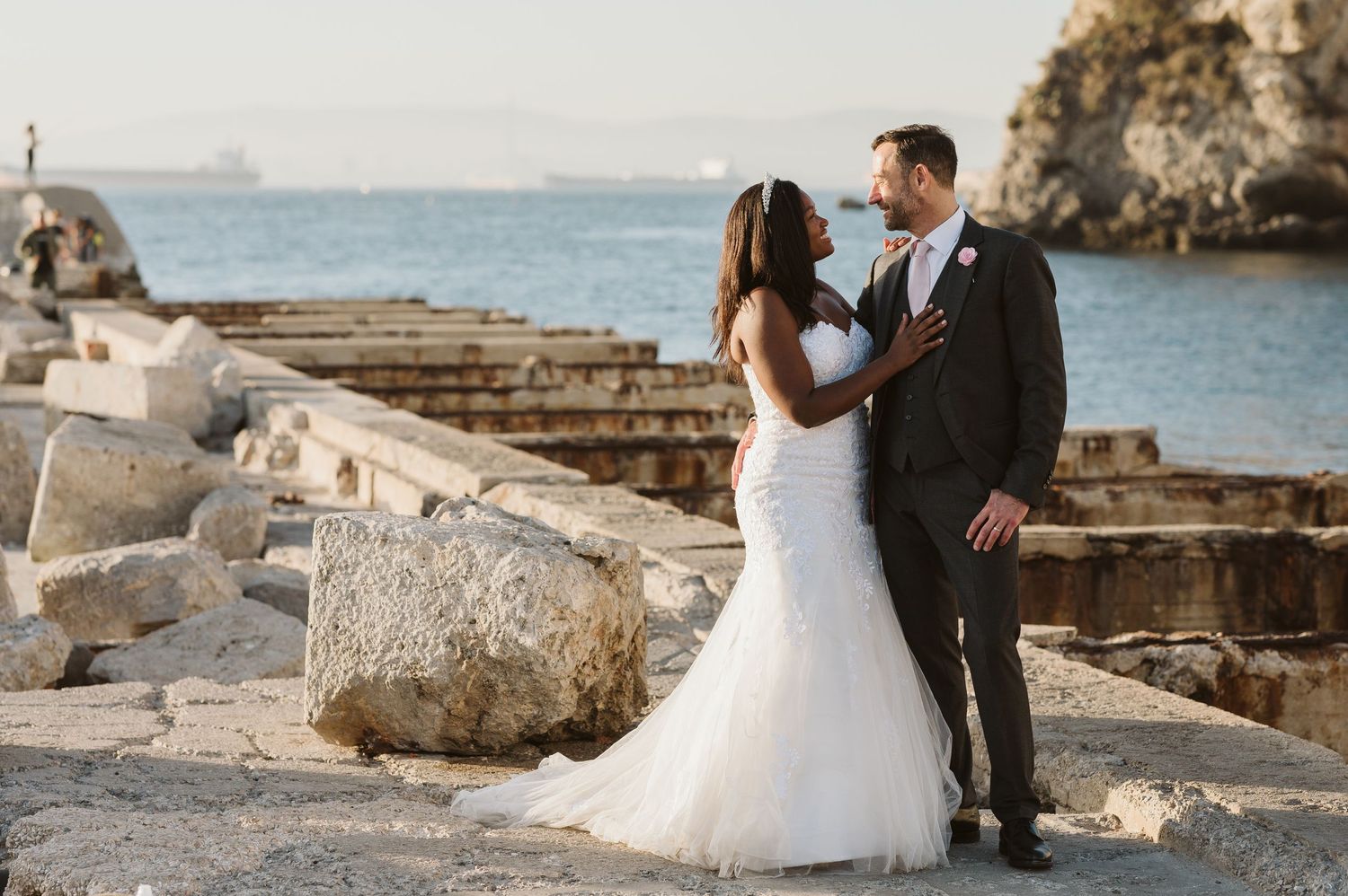 Groom holding bride at rosia Bay