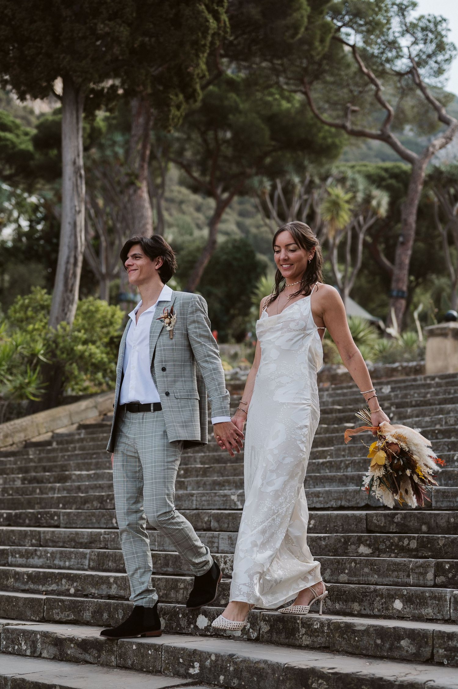 Bride and groom walking down the Alameda stairs