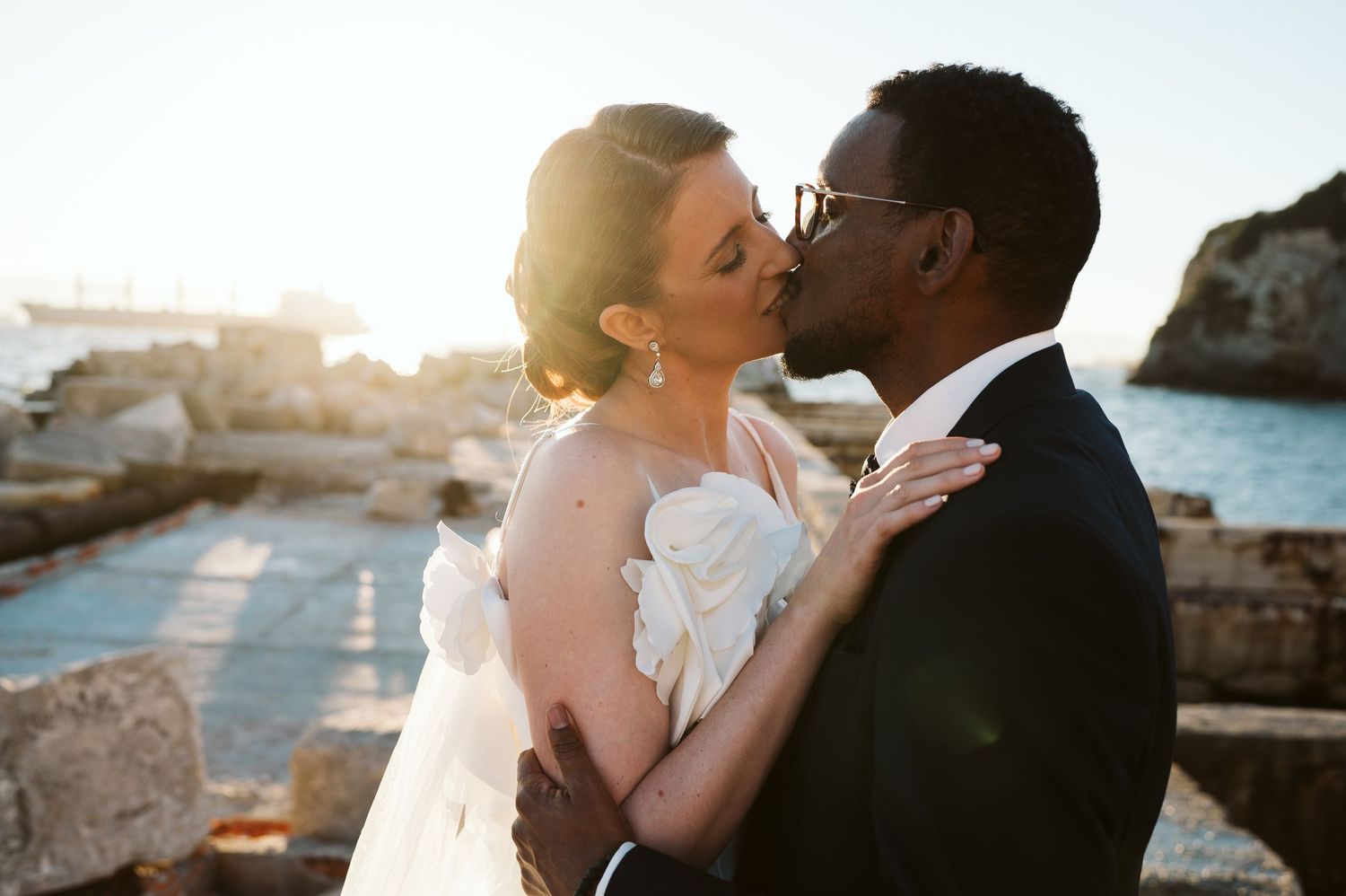 Bride kissing her husband at the Rosia Bay
