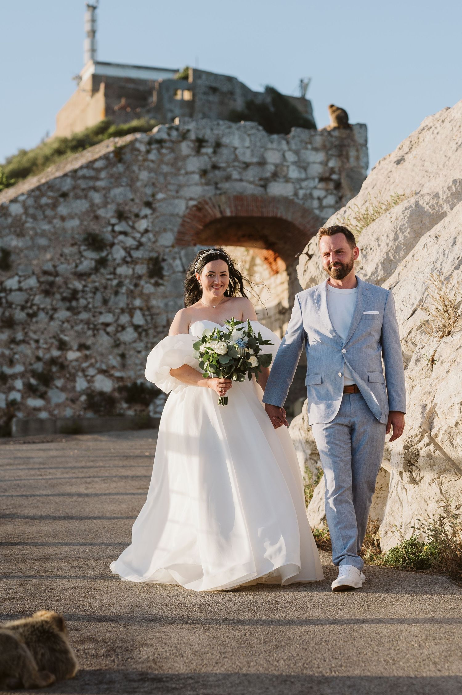 Bride and groom walking on top of the Rock