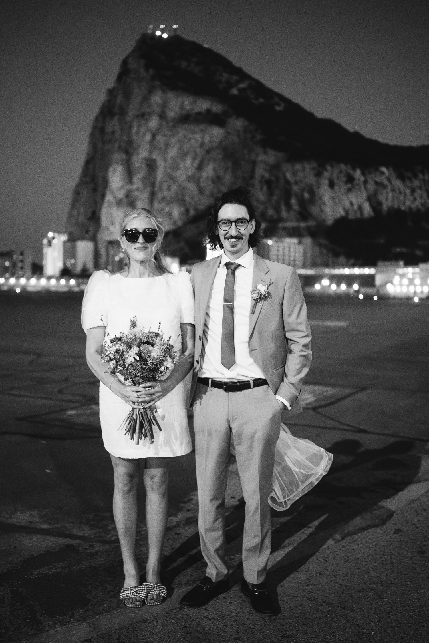 Bride and Groom standing in a cool pose in front of the Rock