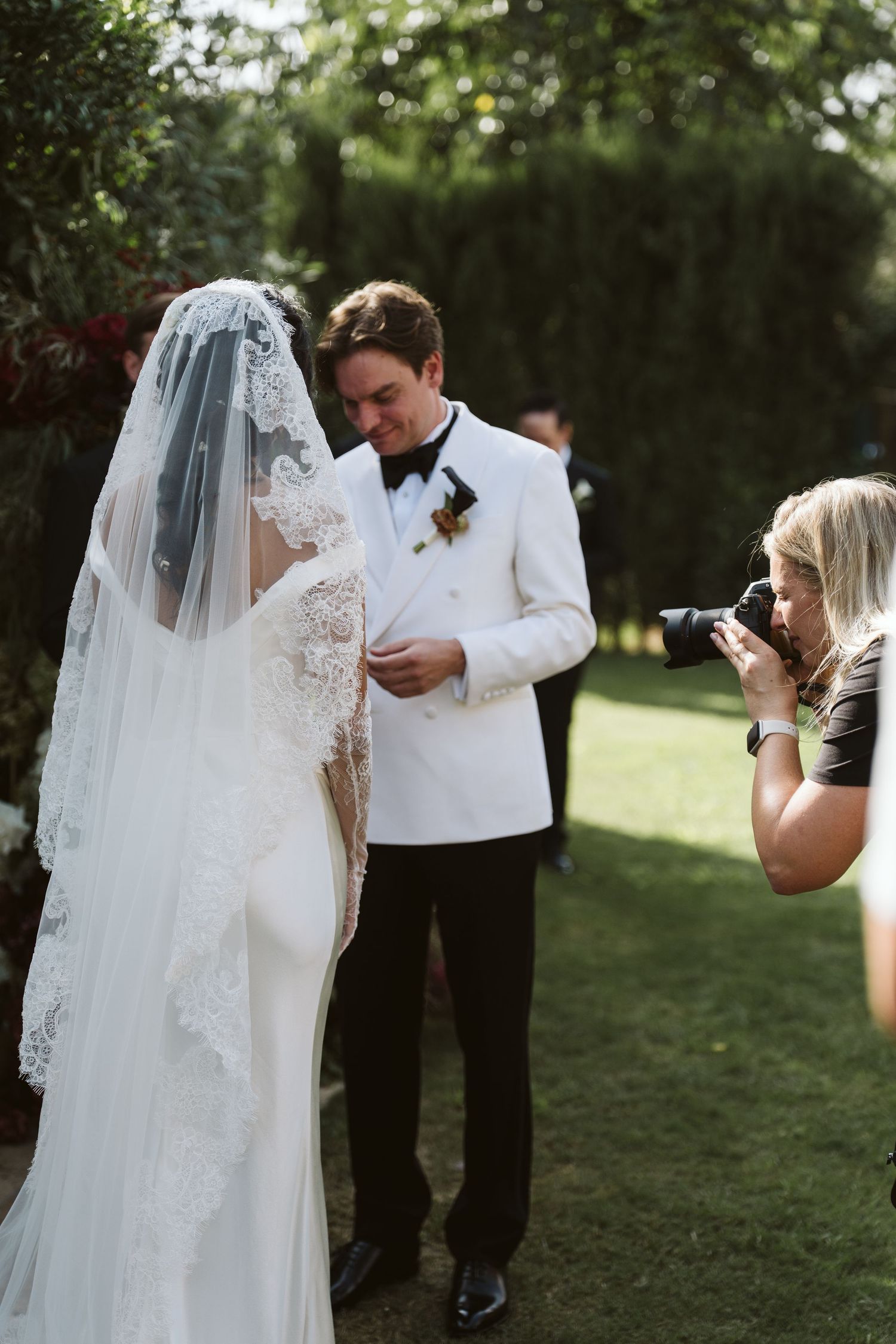 Wedding photographer gently guiding a couple during their portraits