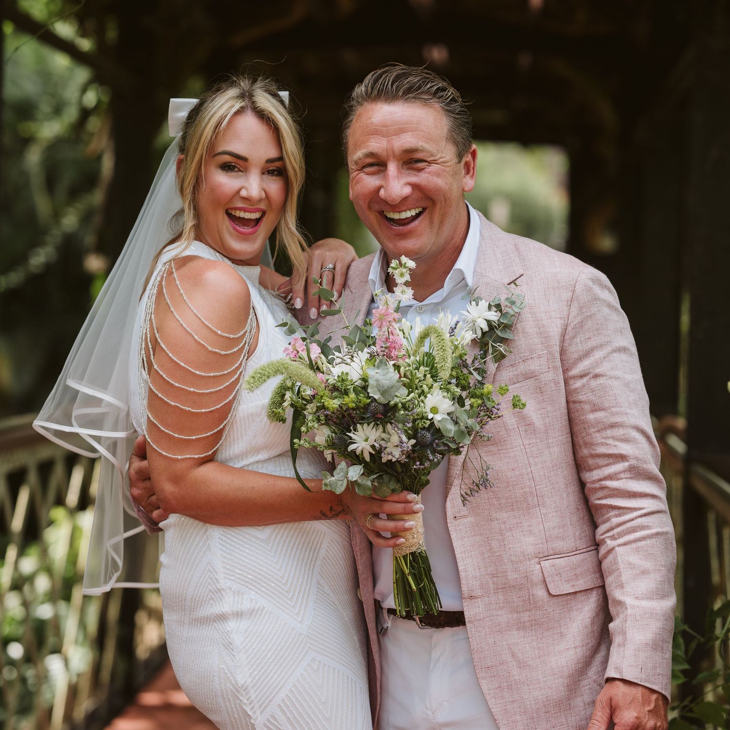bride and groom laughing in a fun way at Alameda Gardens