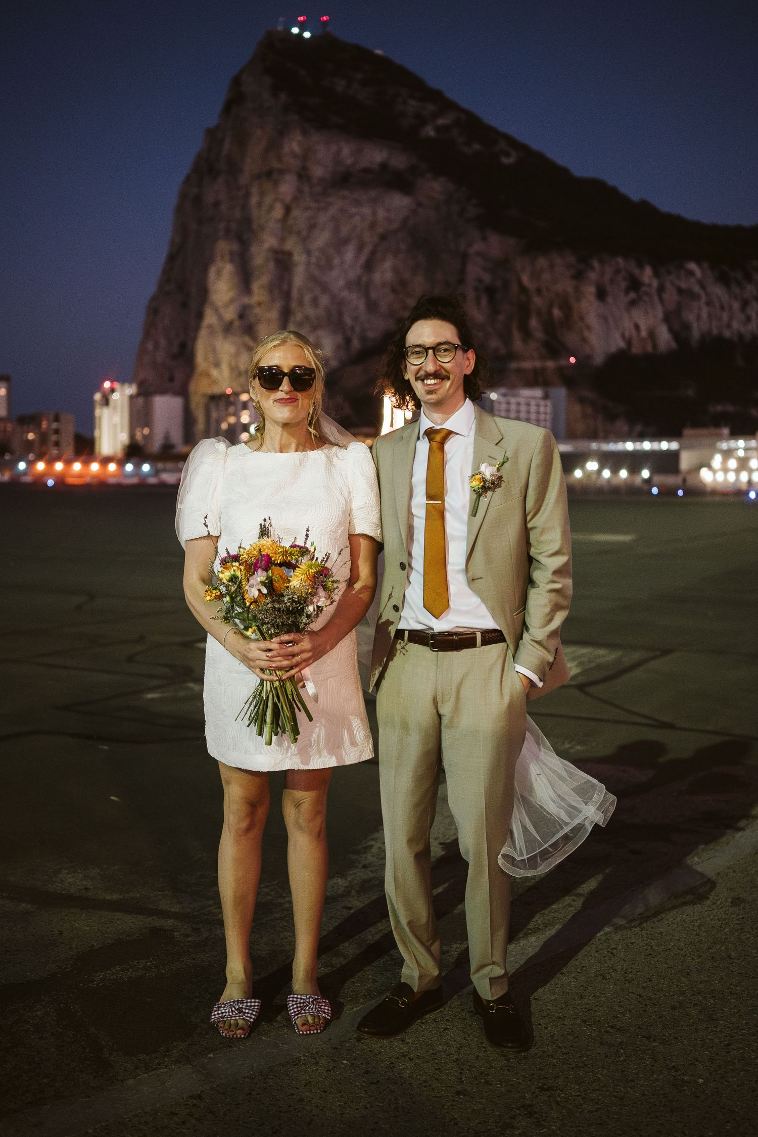 Bride and groom posing for a cool photo at the runway in Gibraltar