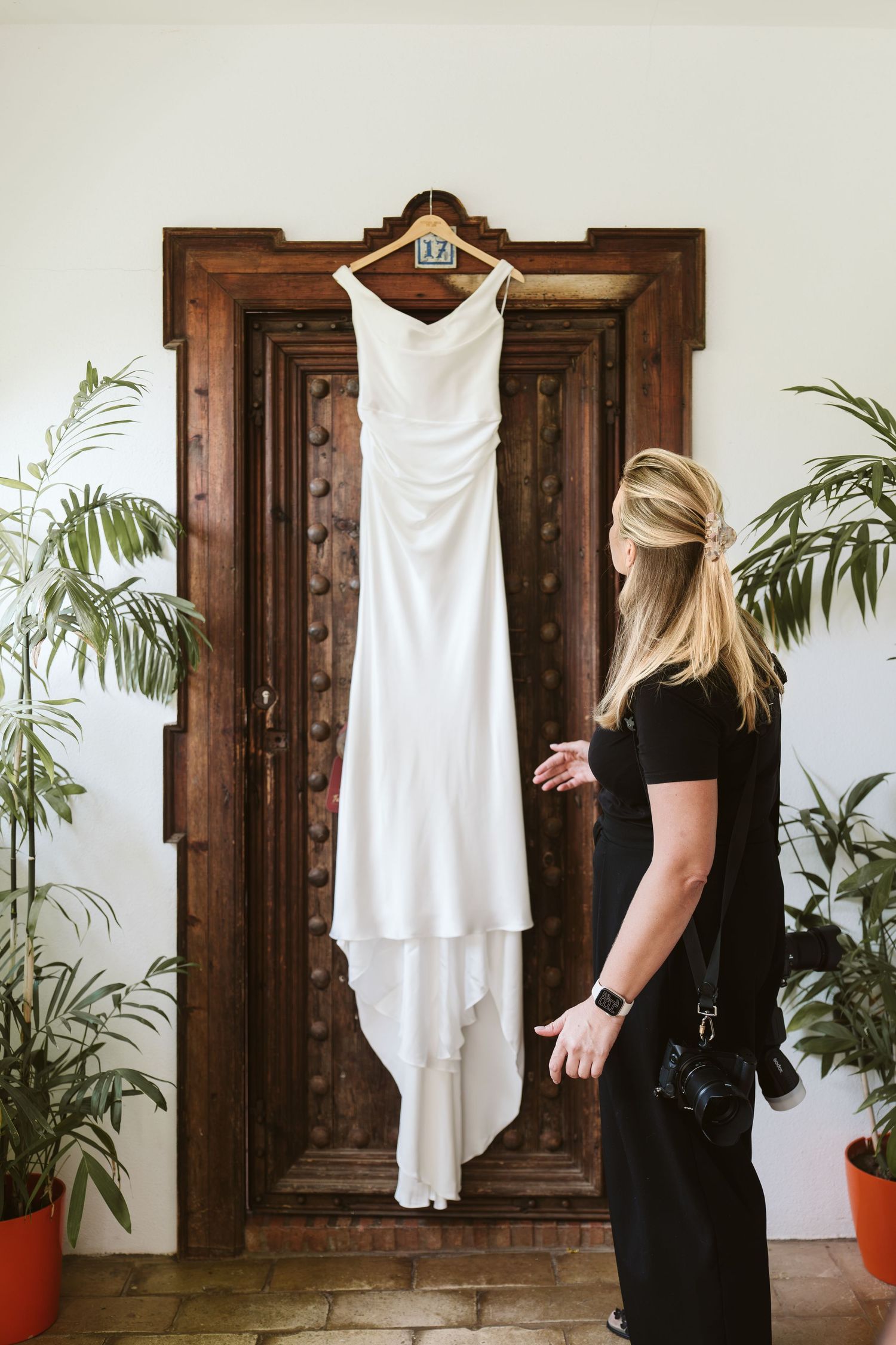 Photographer checking on the wedding dress