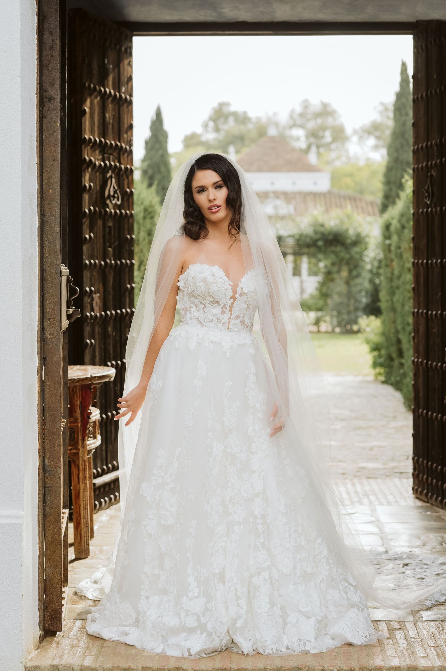Bride standing in the big door at Finca