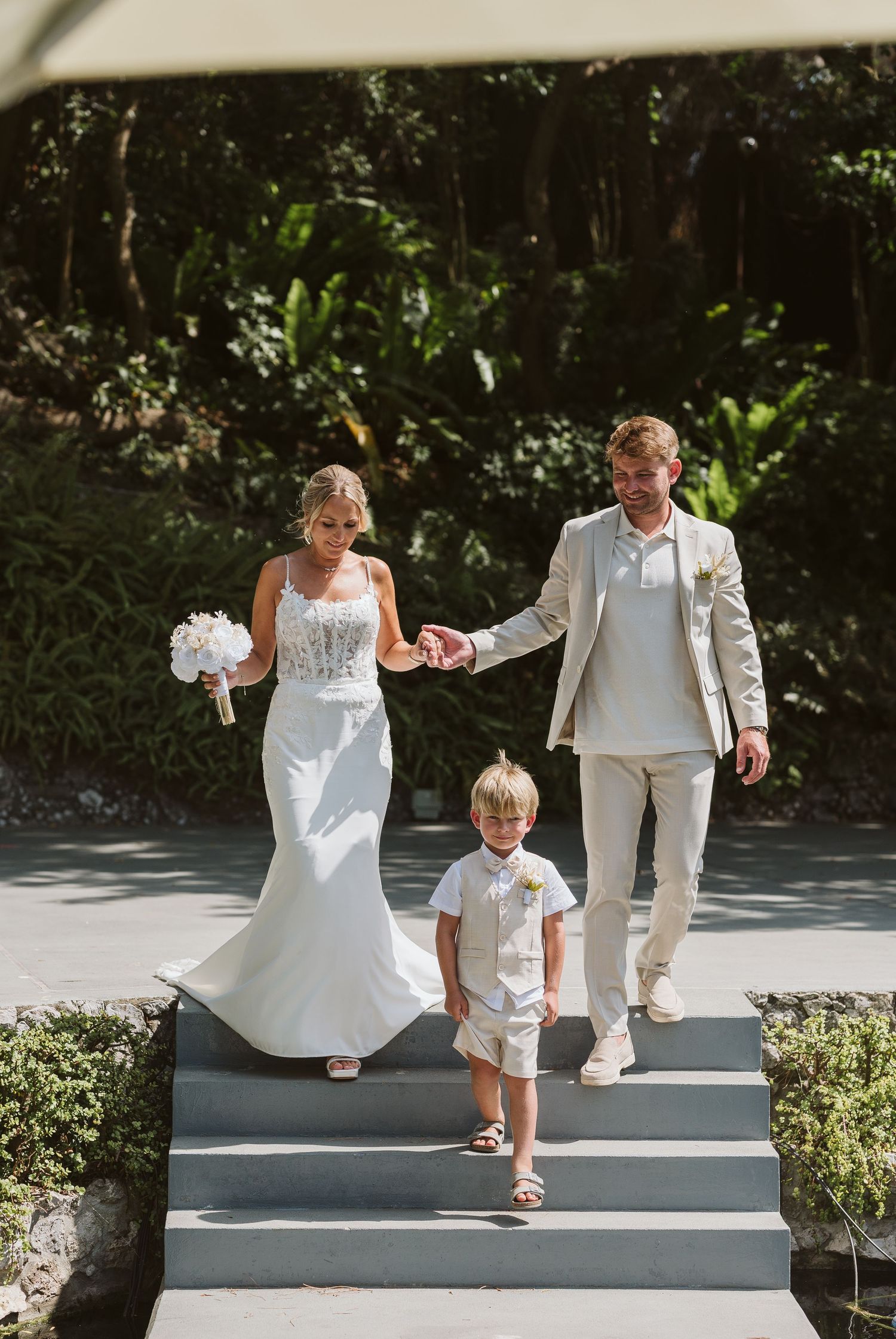 bride groom and the kid walking at the Open Air Theatre in Gibraltar